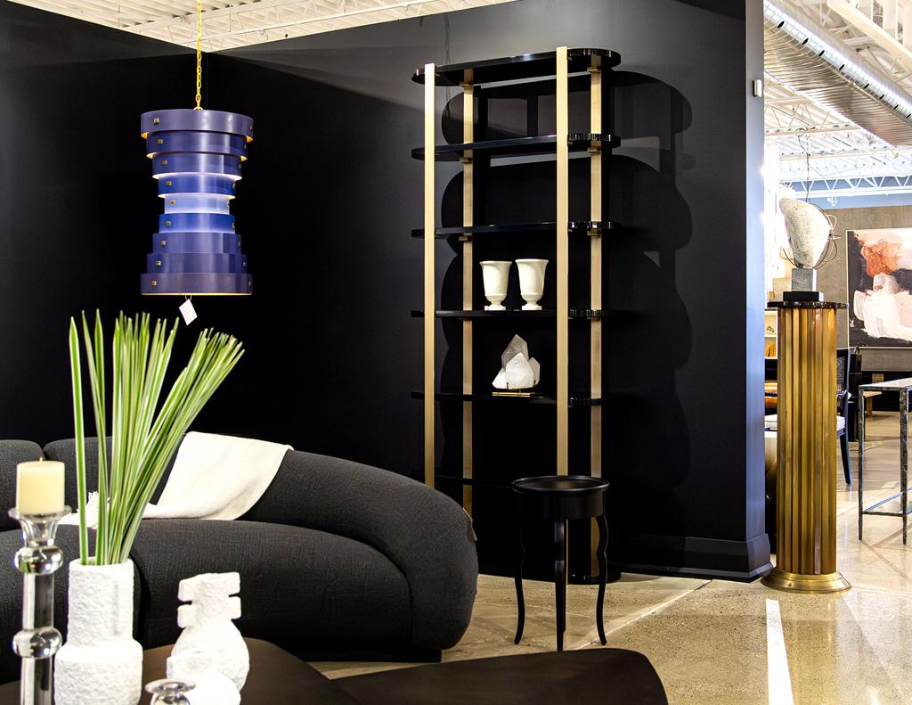 Indulge in the epitome of modern sophistication with our exclusive black bookcase cabinet, a masterpiece handcrafted in Canada. This striking piece boasts an alluring blend of high-gloss black lacquered rounded shelves and a substantial solid metal