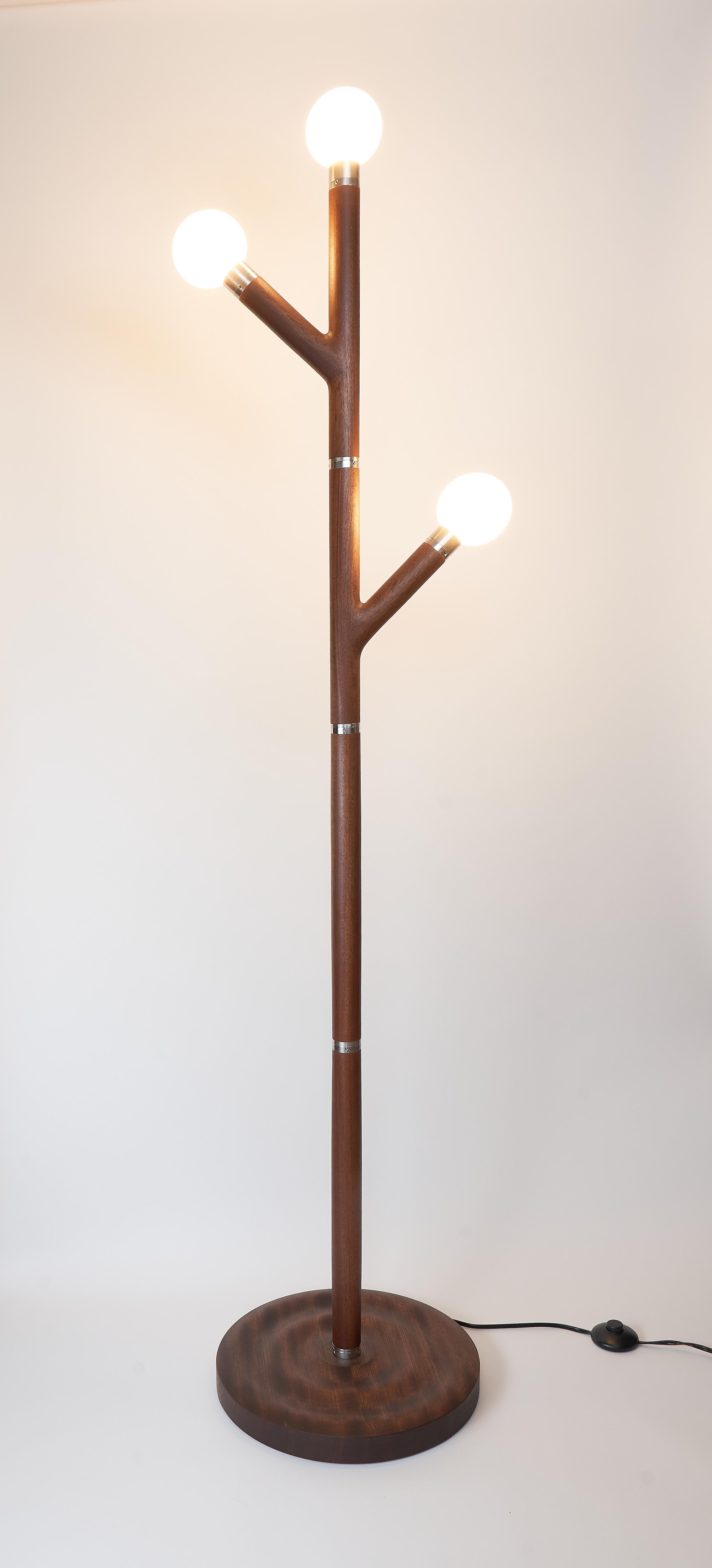 Branch Floor Lamp in Stainless Steel and Sapele Wood

Inspired by the graceful structure of tree branches, this sculptural floor lamp pairs warm, hand-finished sapele wood with the sleek precision of brushed stainless steel. The branching arms rise