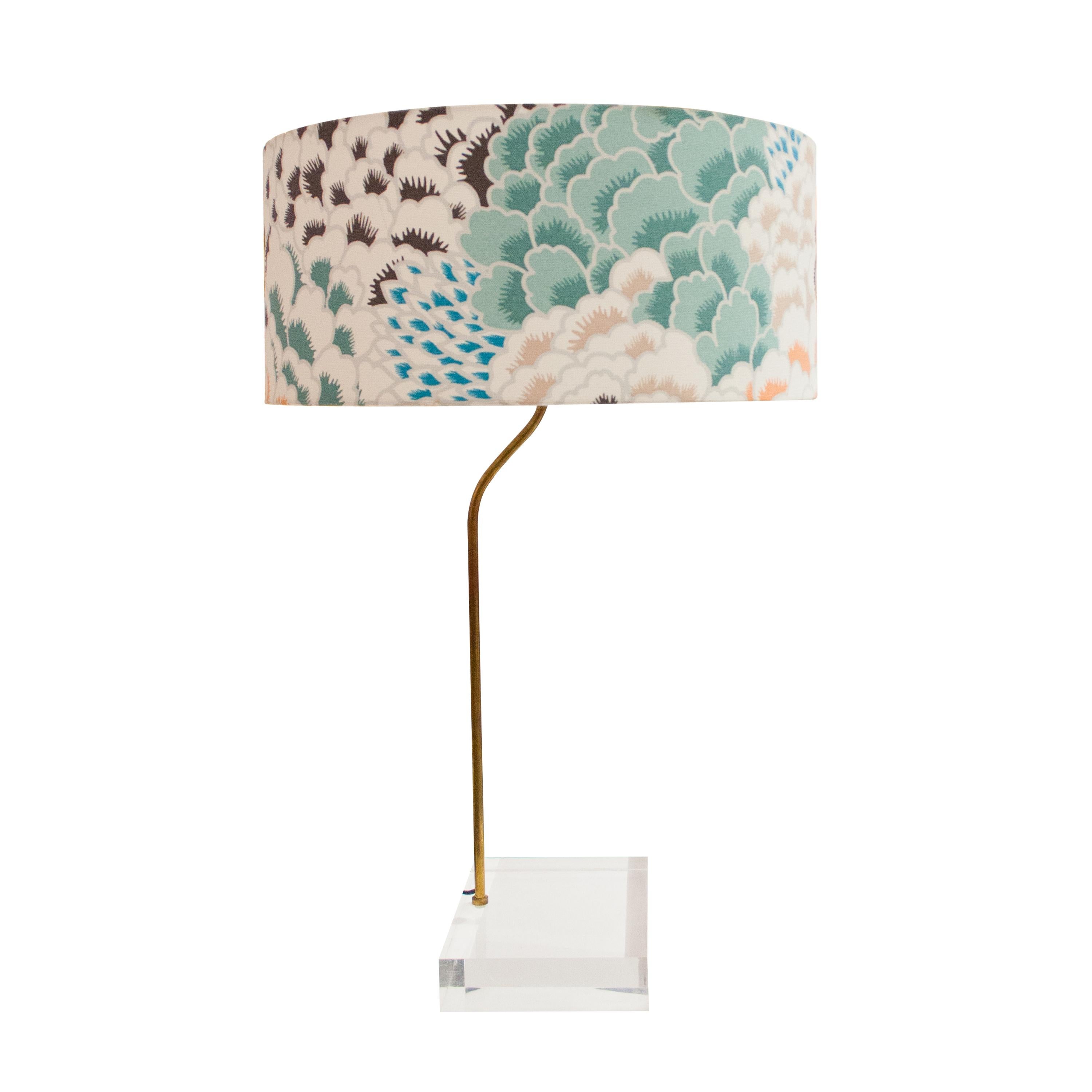 Table lamp composed of a methacrylate base with brass structure and lamp screen with flower print upholstery.
 