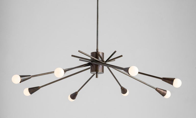 Modern brass chandelier,

Italy 21st century,

Adjustable 8 arm brass chandelier, with rod and canopy. E14 socket,

Measures: 38”diameter x 34.5” height (arms fully extended).
