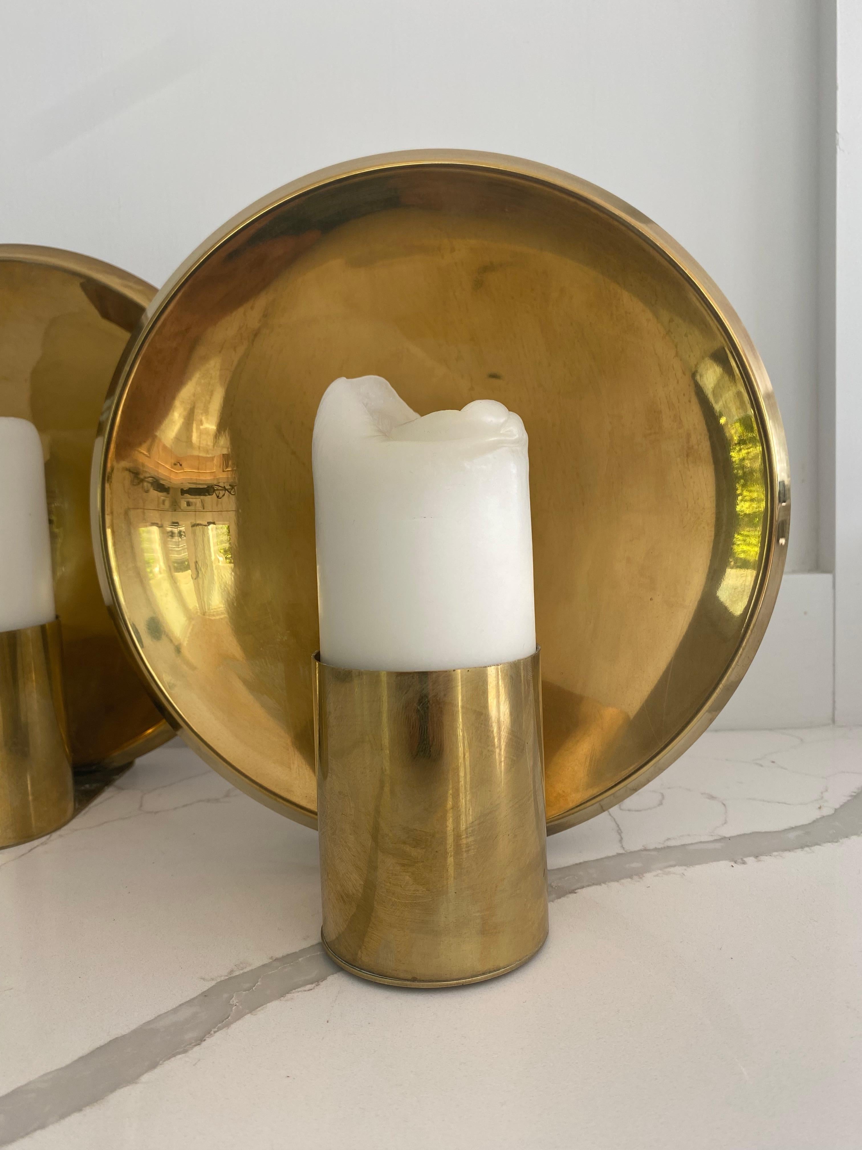 Pair of modern stylish sconces for transitional interiors.
Round 10 inch circular back plate with bold candle holder.
Statement piece.
.
Depth 4.5 inches