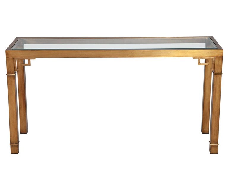 Modern brass console table by Mastercraft 1970’s USA. Original brass console by Mastercraft furniture, America circa 1970’s. Beautiful brass frame with antiqued glaze finish. Original beveled edge glass top has minor scratches consistent with age