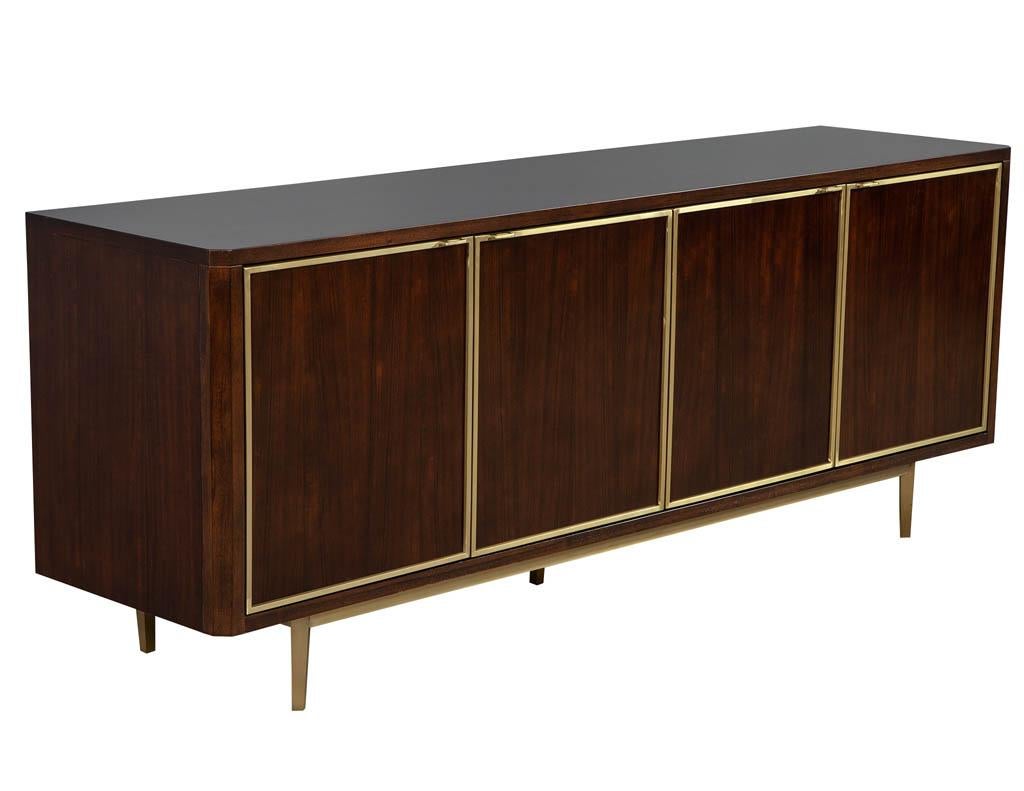 Brass detailed sideboard buffet. Rich mahogany colored finish and brass trim details. Interior features 2 pull out drawers and shelves for storage.
Price includes complimentary curb side delivery to the continental USA.