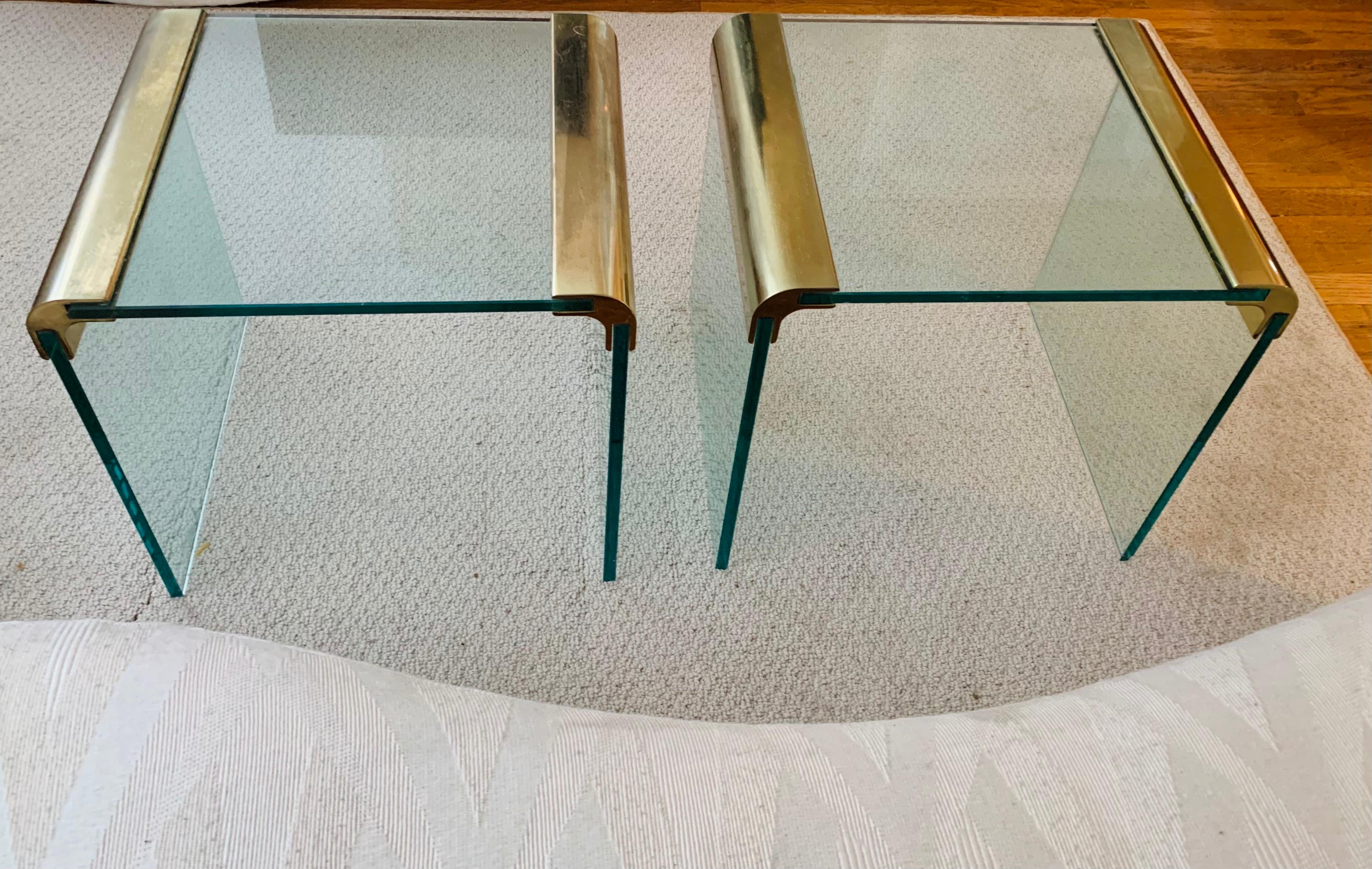 Lovely simple minimalist tables, with brass hardware.

Thick solid glass, 1/4 inch thick. 

Its far more scarce to find the end tables than it is the larger coffee & console tables. 

Very clean nice condition.