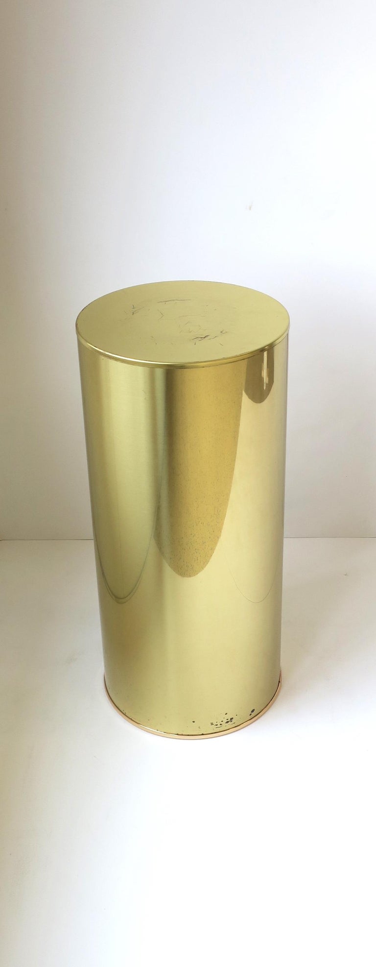A Modern style Post-Modern period brass plated pedestal column pillar stand signed by designers C. Jere, circa 1970s, 1980s. A great piece for display, sculpture, plant, etc., or even as a side/drinks table albeit slightly on the higher side.