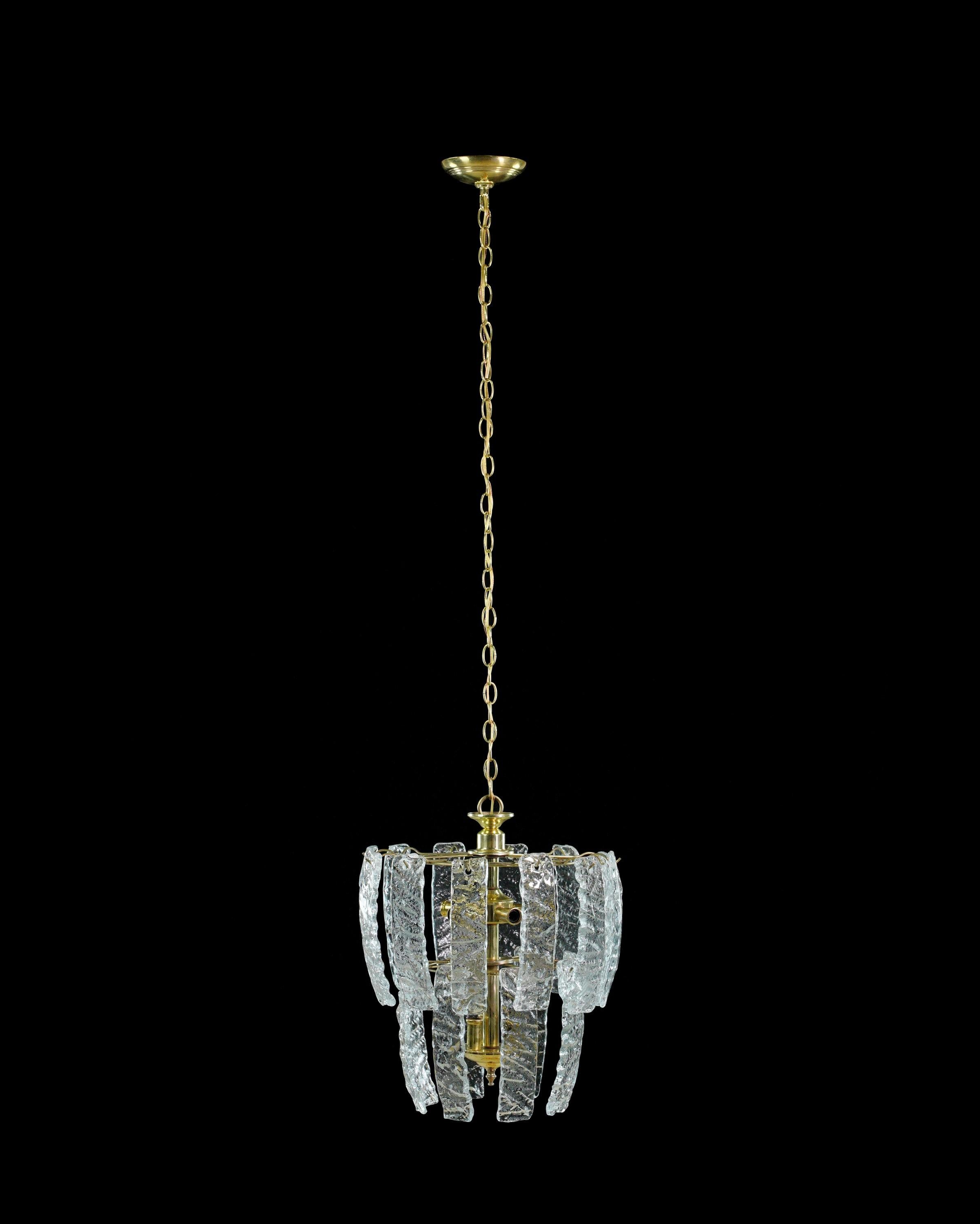 Italian Modern style chandelier crafted from brass-plated steel with a cascade of hand formed clear glass panels. This sleek and contemporary design exudes sophistication, creating a stunning focal point that illuminates with a dazzling play of