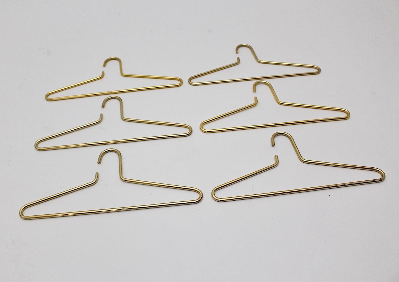 This modern set of six vintage cloth hangers was made of brass-plated metal.
Very good condition with some signs of age.
Approximate measures:
Width 42 cm
Height 19 cm
Thickness 0.8 cm.