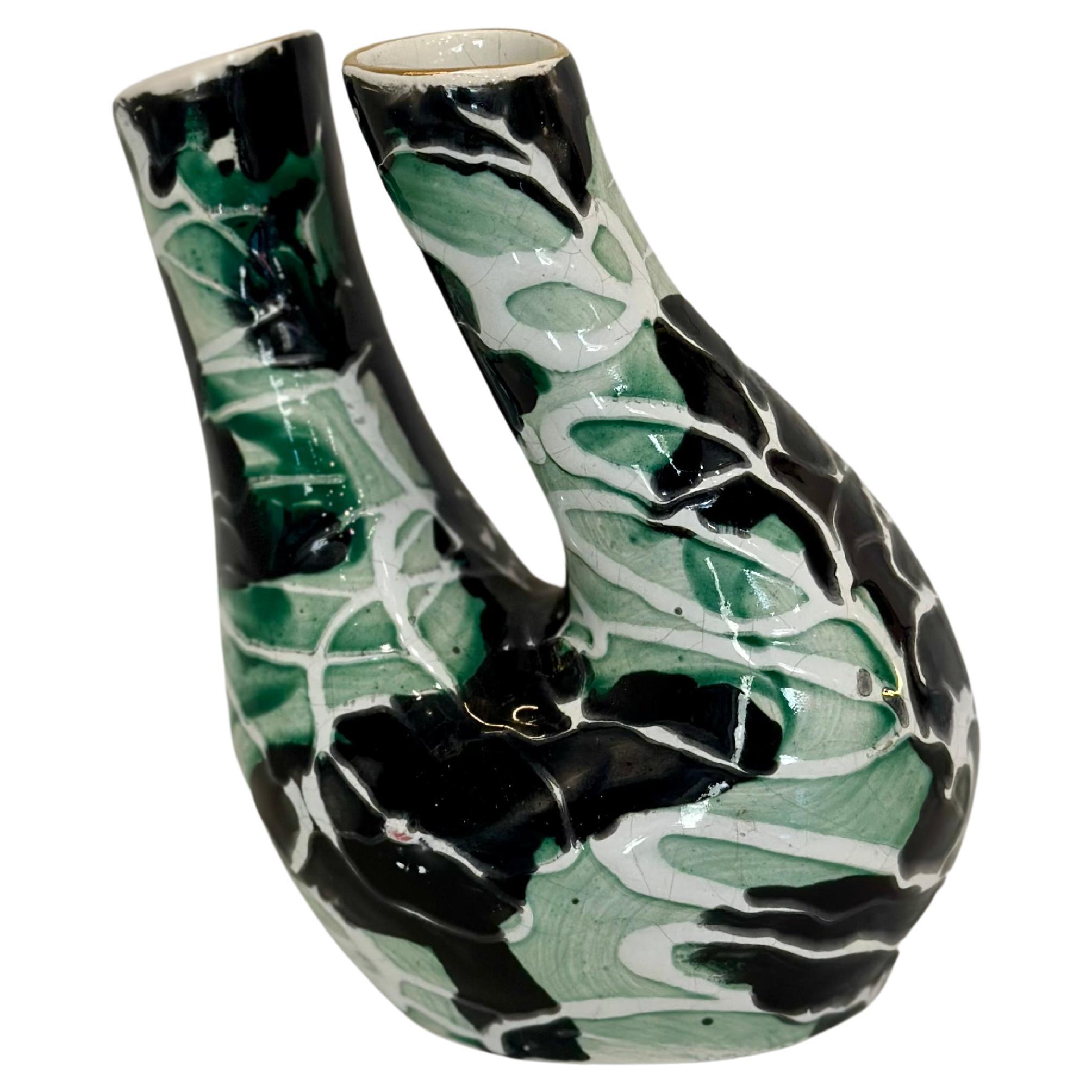 This modern Brazilian ceramic vase dates from about 1950. Made from glazed ceramic in shades of green, black and white, it measures 18.5 cm high, 15 cm wide and 12 cm deep.

The use of enamelled ceramic creates a smooth and shiny surface that