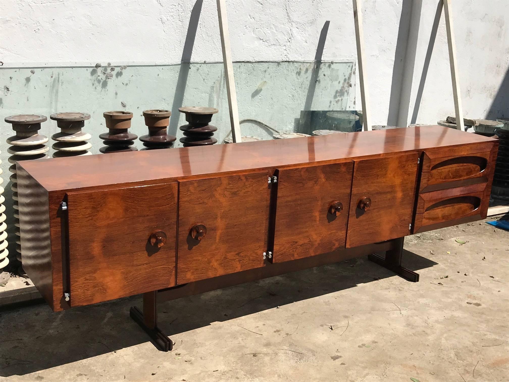 Named the 'Novo Rumo' this modern Brazilian sideboard is made of rosewood with very stylish design and unique drawers. Very good vintage original condition, never restored just polished.