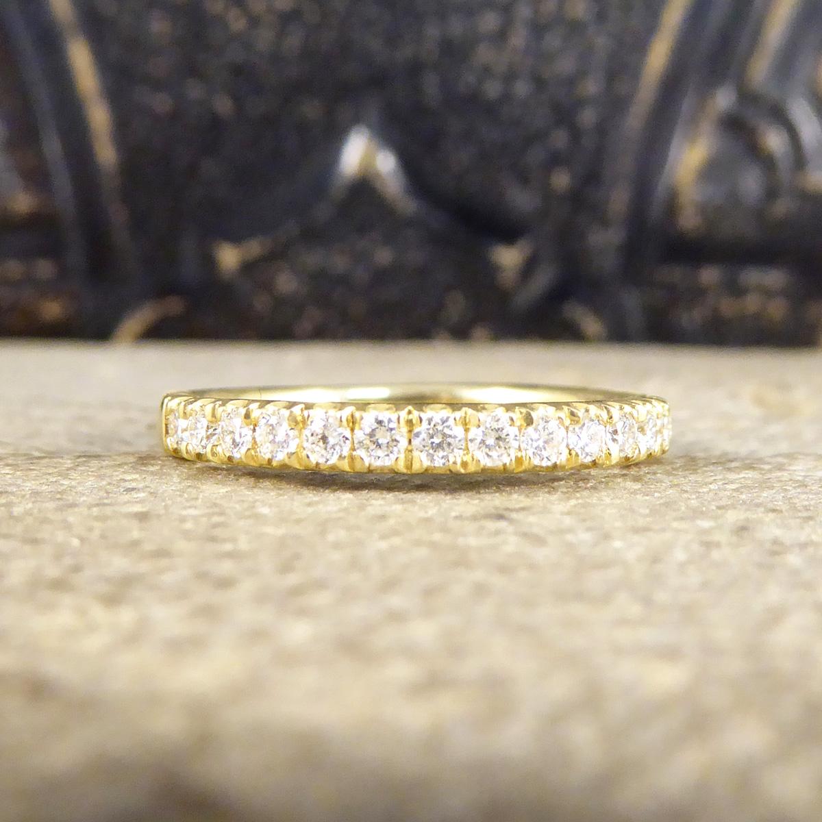 The perfect ring for any Yellow Gold lover to stack, wear independently, as a wedding or eternity band. It features 17 clean and bright Brilliant Cut Diamonds weighing a total of 0.35ct it sparkles from every angle on the top of the finger with the