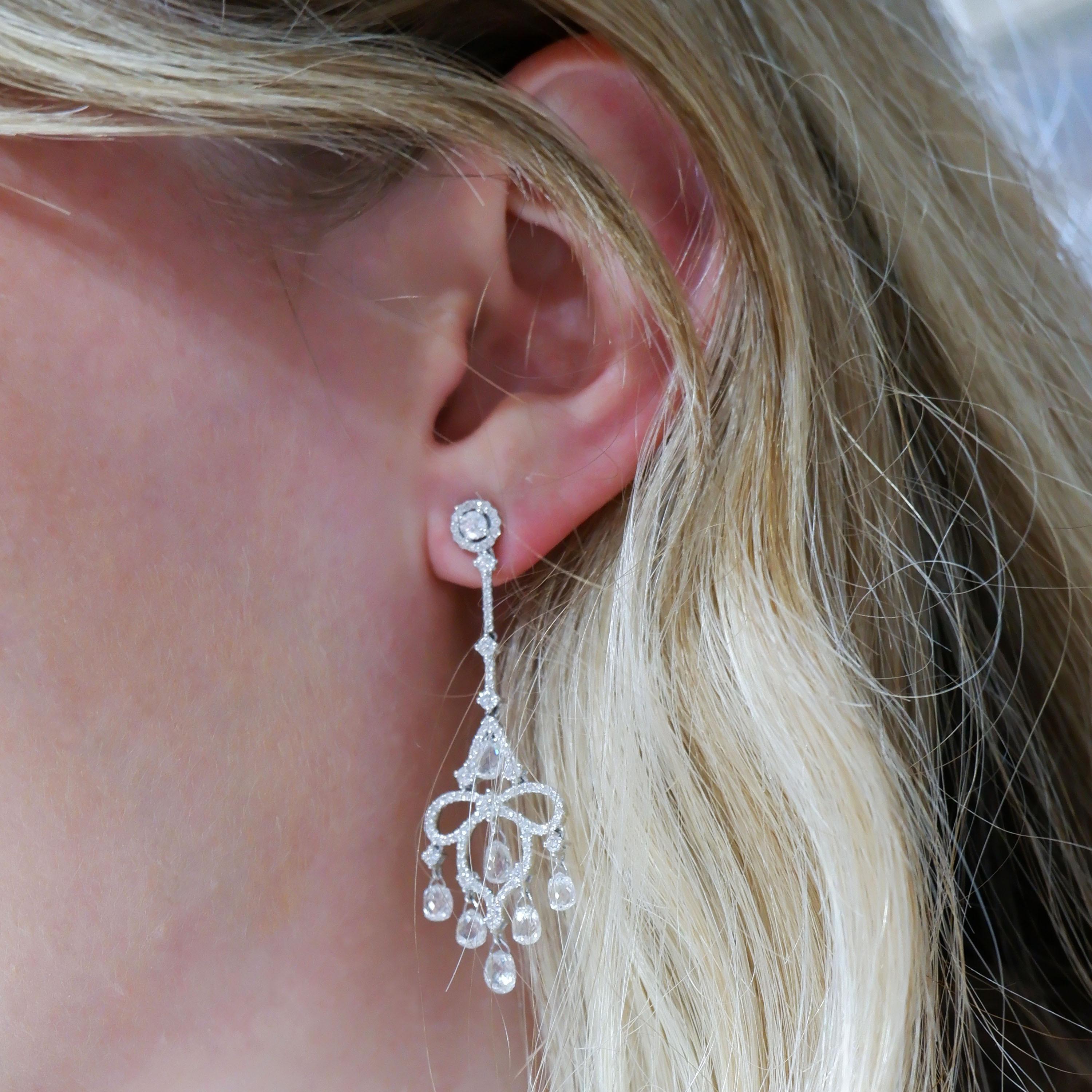 A pair of modern briolette diamond and white gold drop earrings, with round brilliant-cut diamond micro pavé set cluster tops and openwork drops, set with round brilliant-cut diamonds, suspending briolette-cut diamond pendants, with a total diamond
