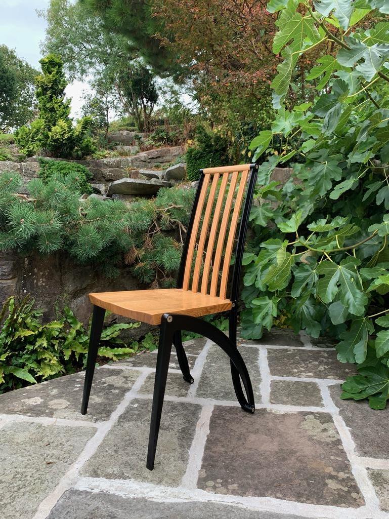 Introducing the Mantíde, the epitome of modern dining luxury – the meticulously crafted Oak and Black Powder Coated Dining Chair. This masterpiece transcends the ordinary, where exquisite design meets unparalleled comfort, making it an ideal