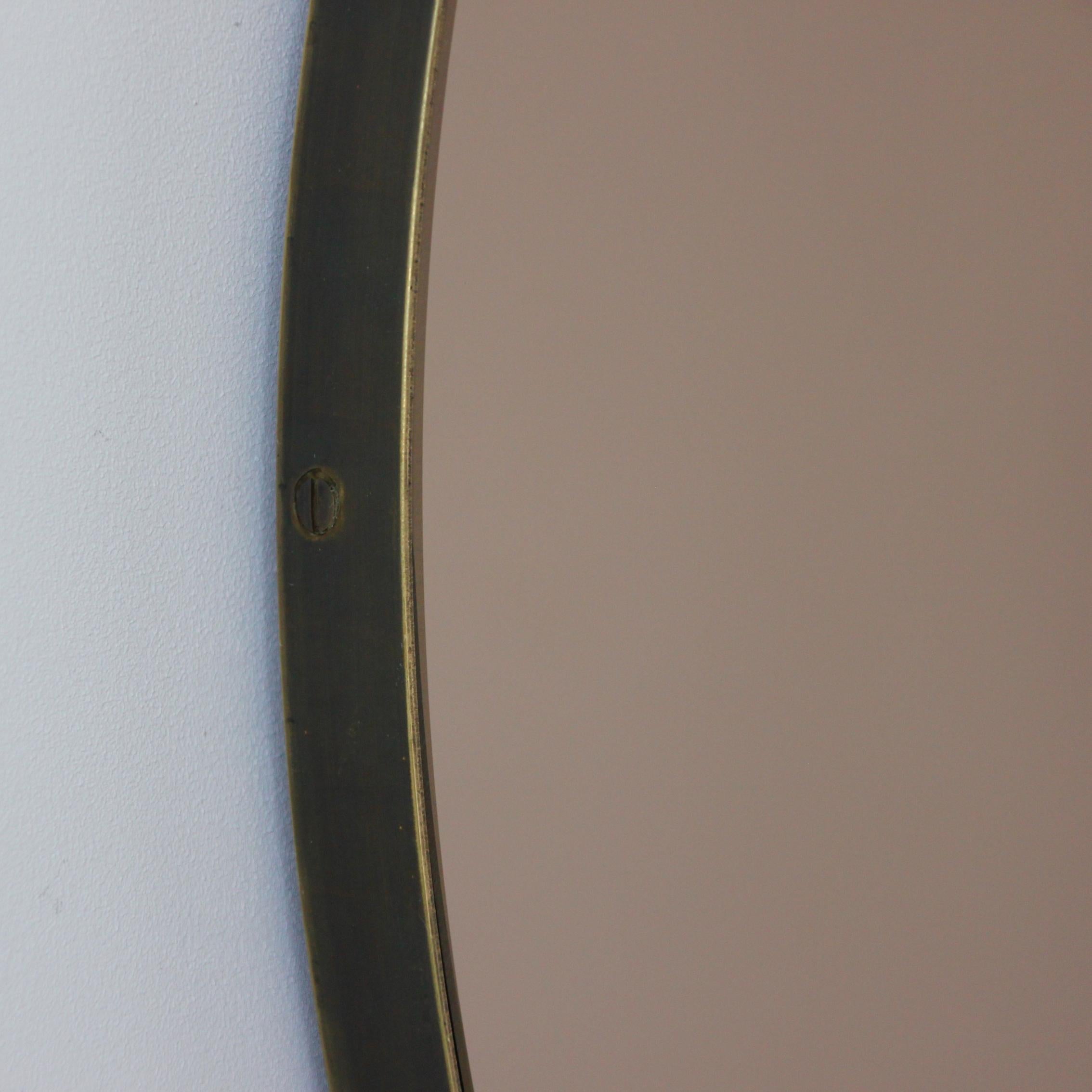 Contemporary bronze tinted Orbis™ round mirror with a minimalist solid brass frame with a bronze patina finish. Designed and handcrafted in London, UK.

Medium, large and extra-large mirrors (60, 80 and 100cm) are fitted with an ingenious French