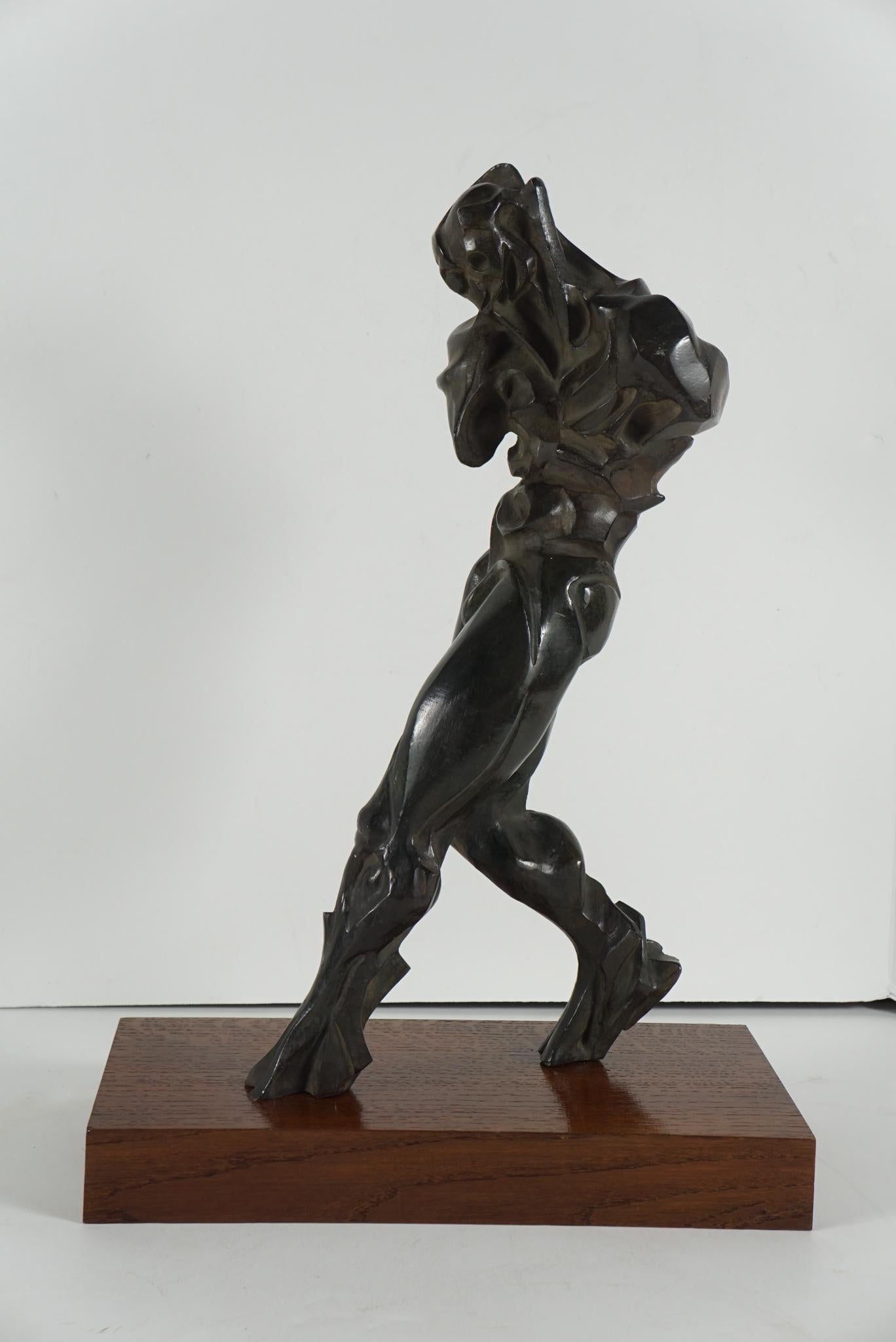 Cast Bronze work by Paris based artist and sculptor Manuel Fernandez entitled “The Walker” cast in 2001. The original single work, done in 2000, has a solid cast bronze slab base as part of the work's body and here the work has been reinterpreted by