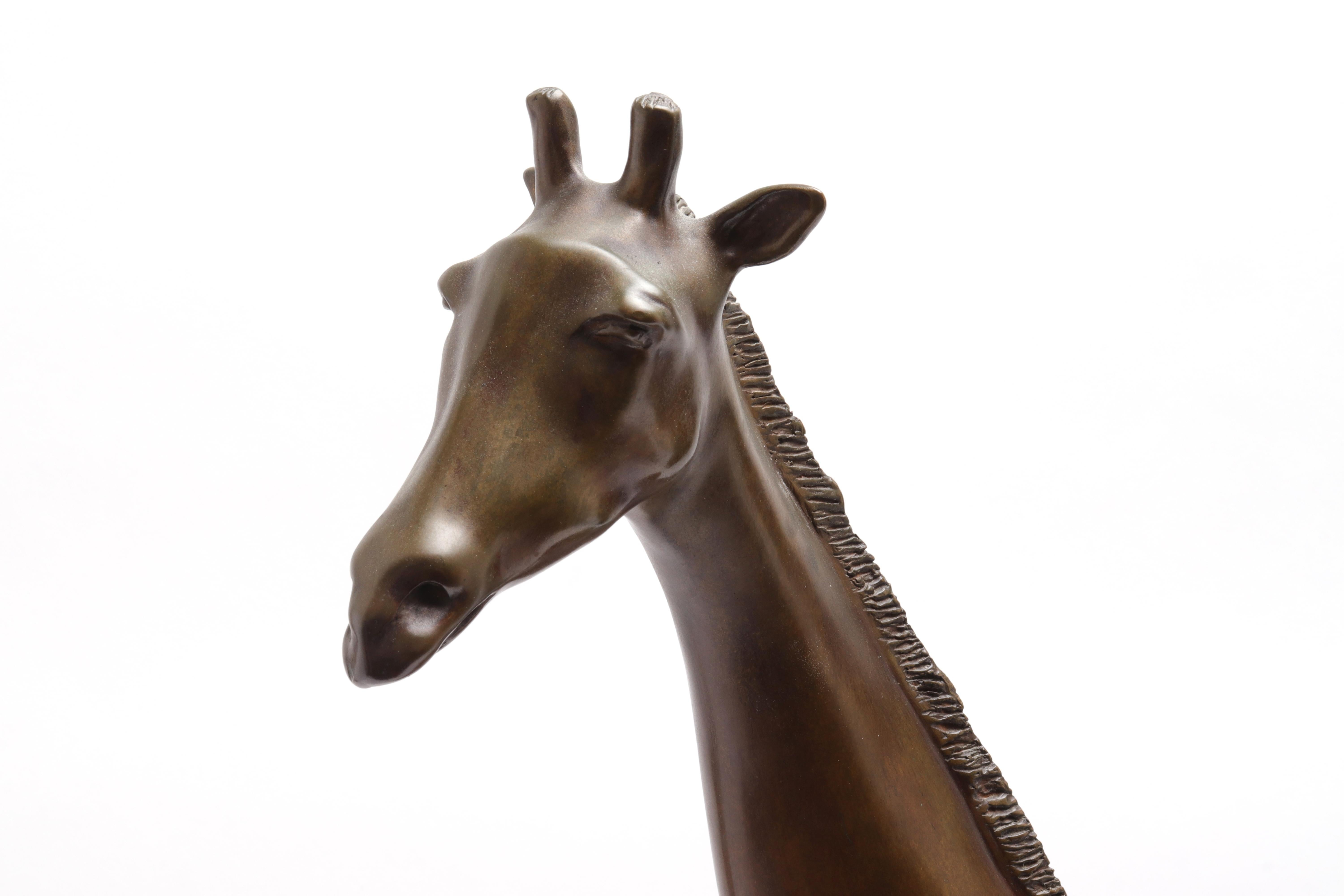 Modern bronze sculpture of a giraffe. The piece is bearing a monogram signature 