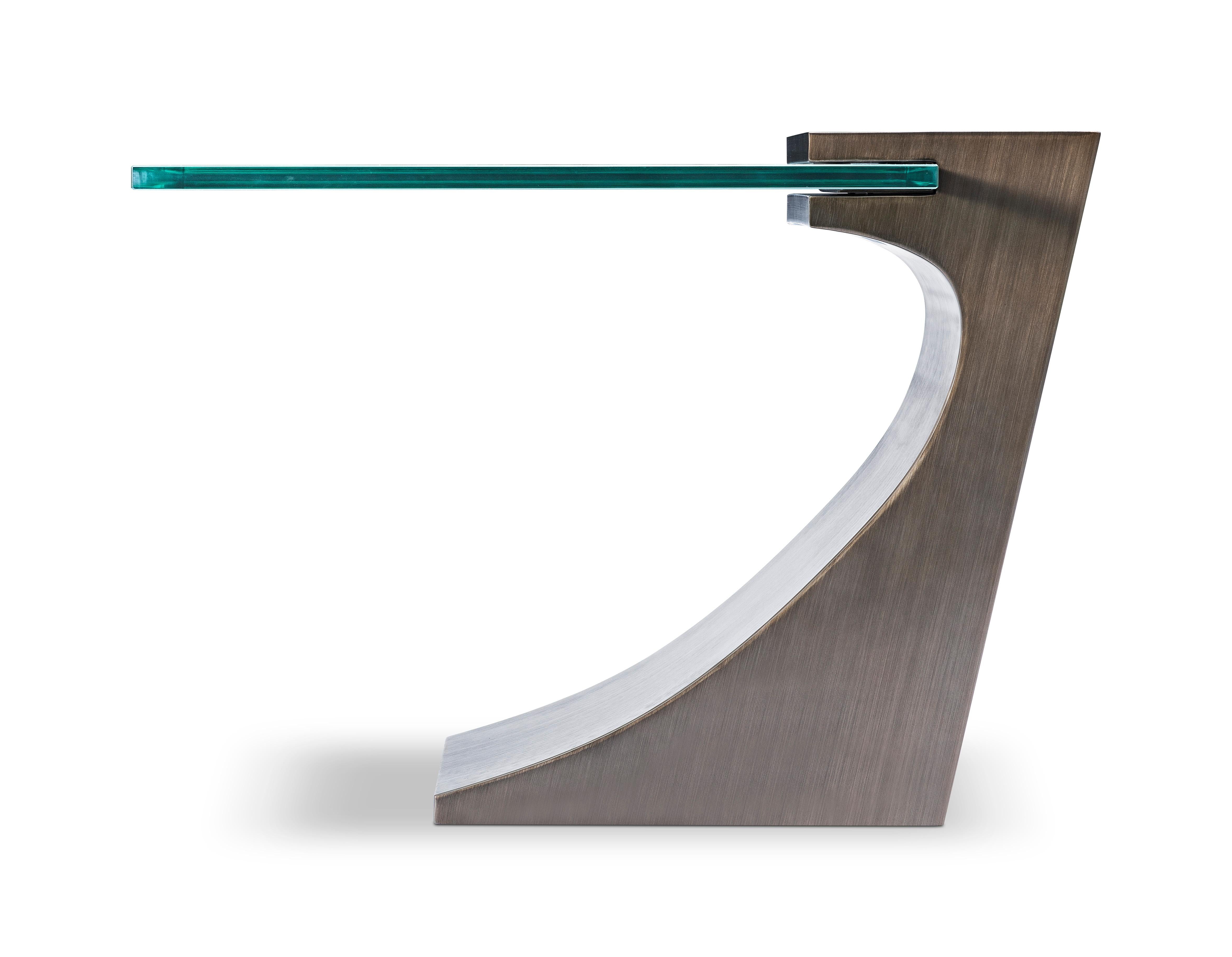 Modern Bronze lamp table designed by Greg Sheres.  Cantilevered 3/4” glass top.  This sculptural bronze table is one of Greg’s classic designs.  It can be paired with the matching cocktail table to create nesting tables of different heights.
This