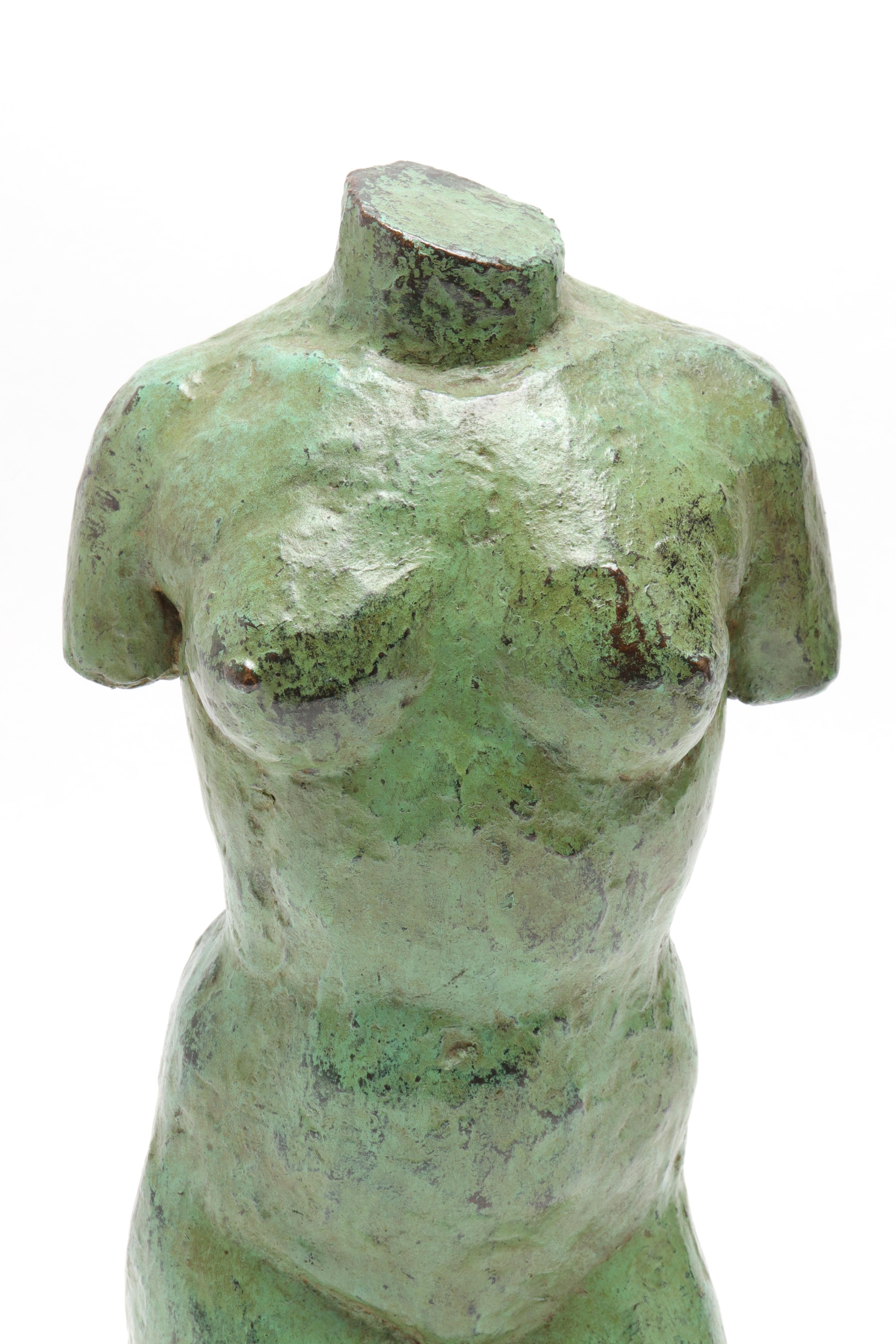 Modern bronze sculpture, depicting a torso of a female nude. The piece has verdigris patina and is mounted to a black stone base. From a private residence at the Pierre Hotel in New York City.
 In great vintage condition with age-appropriate wear.