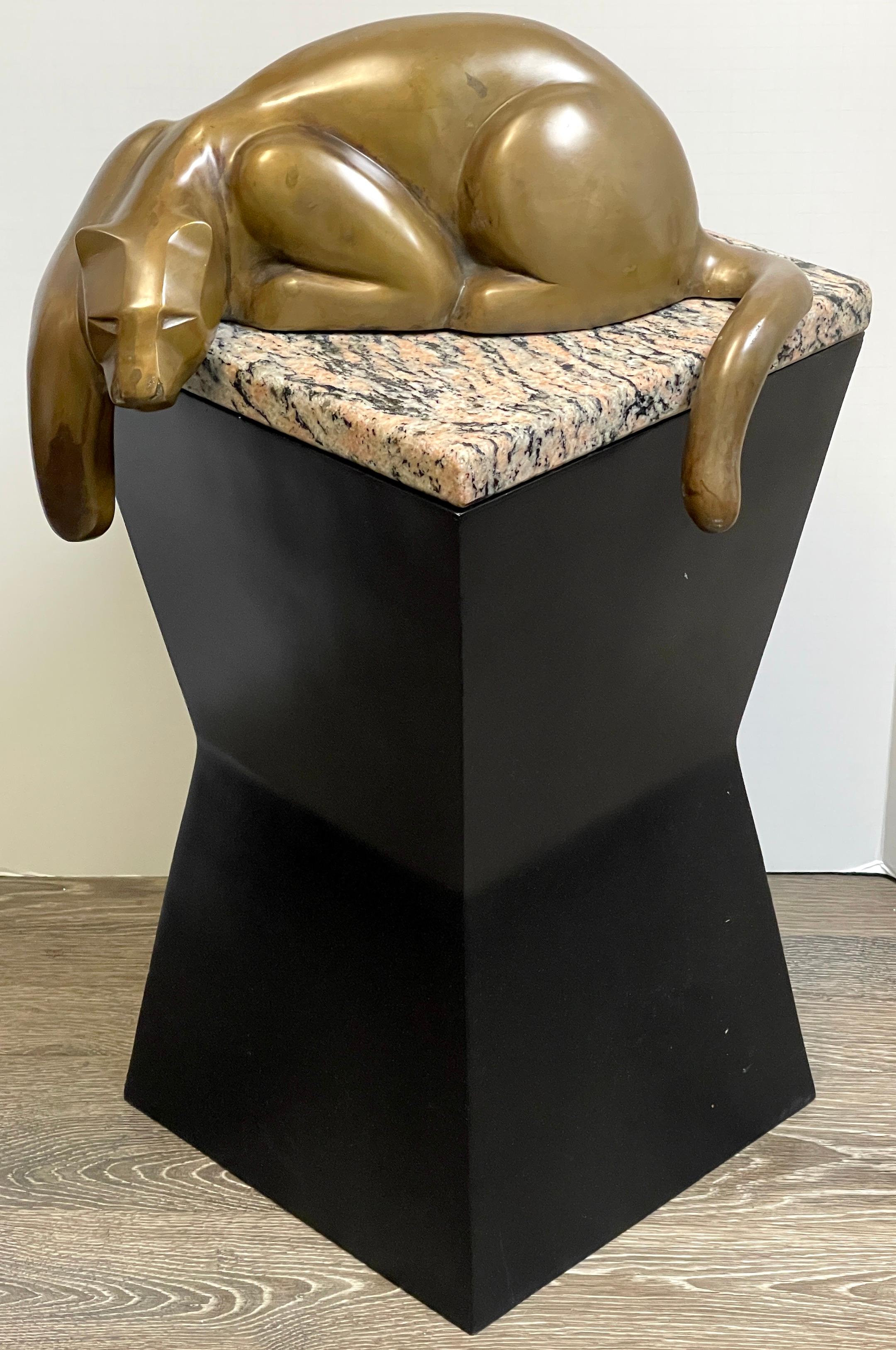 Modern bronze of a resting panther, in the style of Carlo Bugatti 
The relaxed cast patinated bronze, resting premaritally on a multi-colored granite top, on a tapering square ebonized wood pedestal base.
Overall dimensions are 28