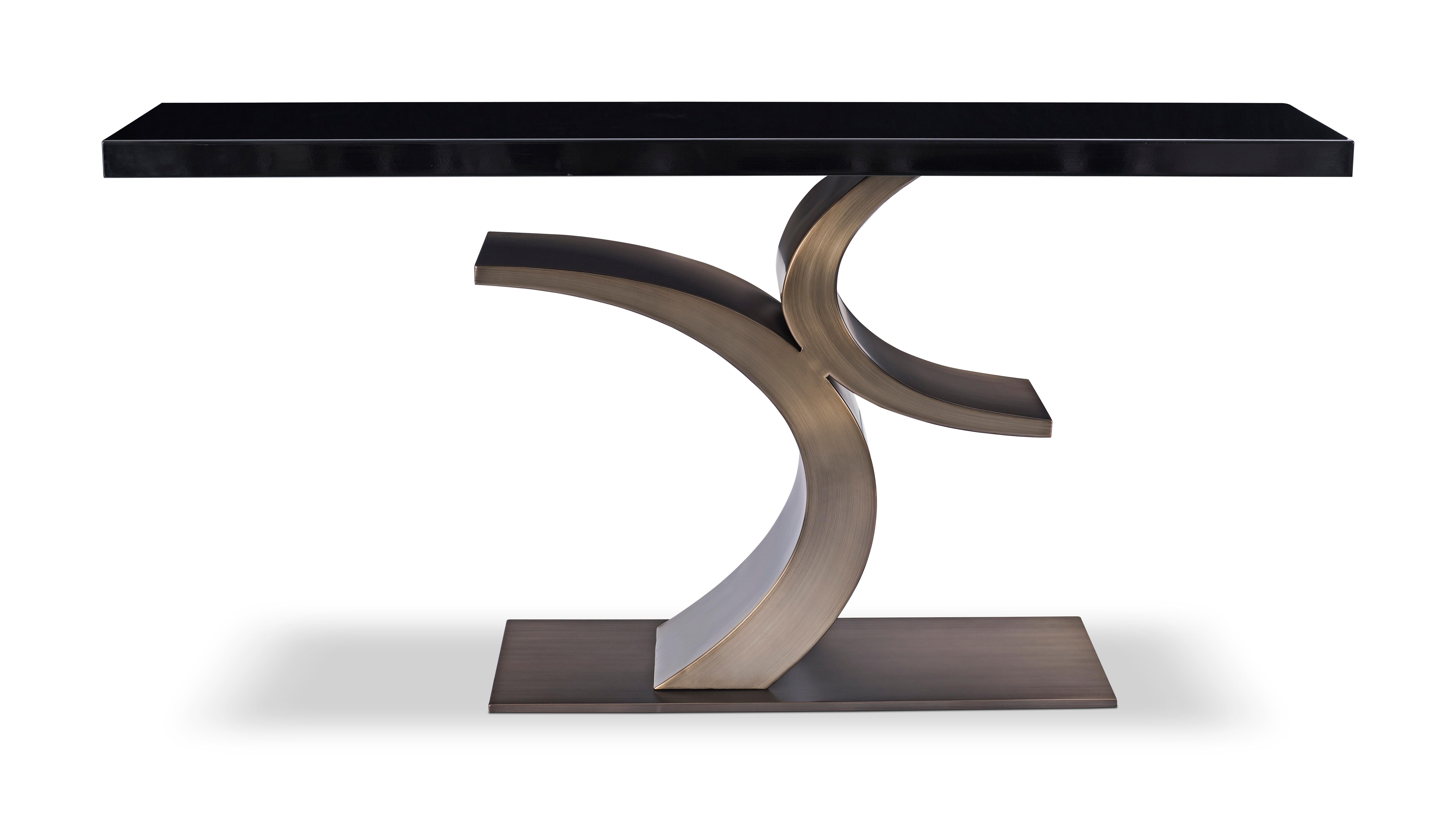 Modern Bronze and black Lacquer console table designed by Greg Sheres.  This is our “Cosmopolitan” console table.  The base is finished in Antique Brass and The table top is polished black lacquer.  
The graceful sweeping sculpture of the base is