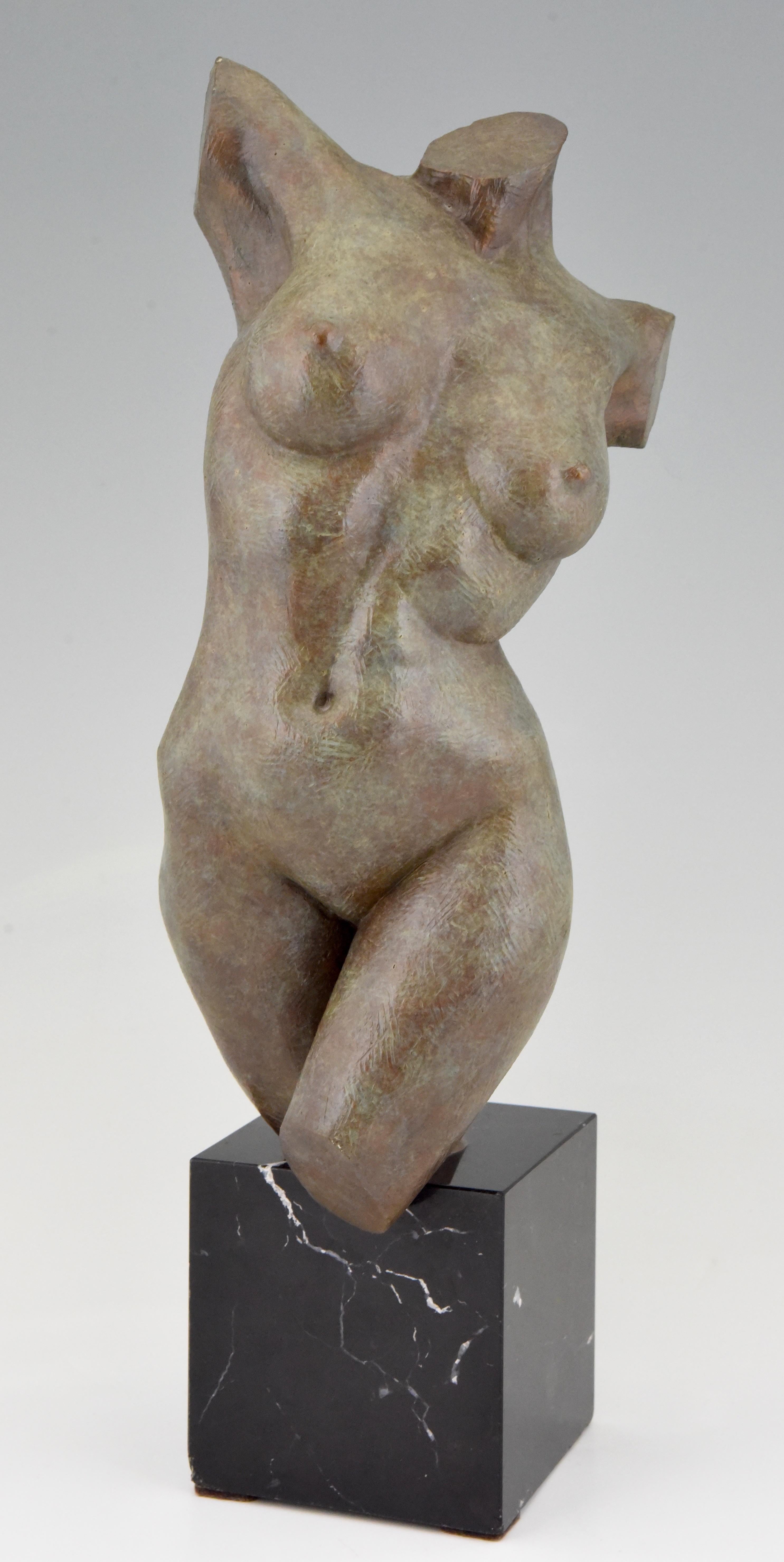 Modern bronze sculpture of a female torso by the American artist Lena Olson. The bronze is numbered and dated 1997. The patinated bronze stands on a marble base.