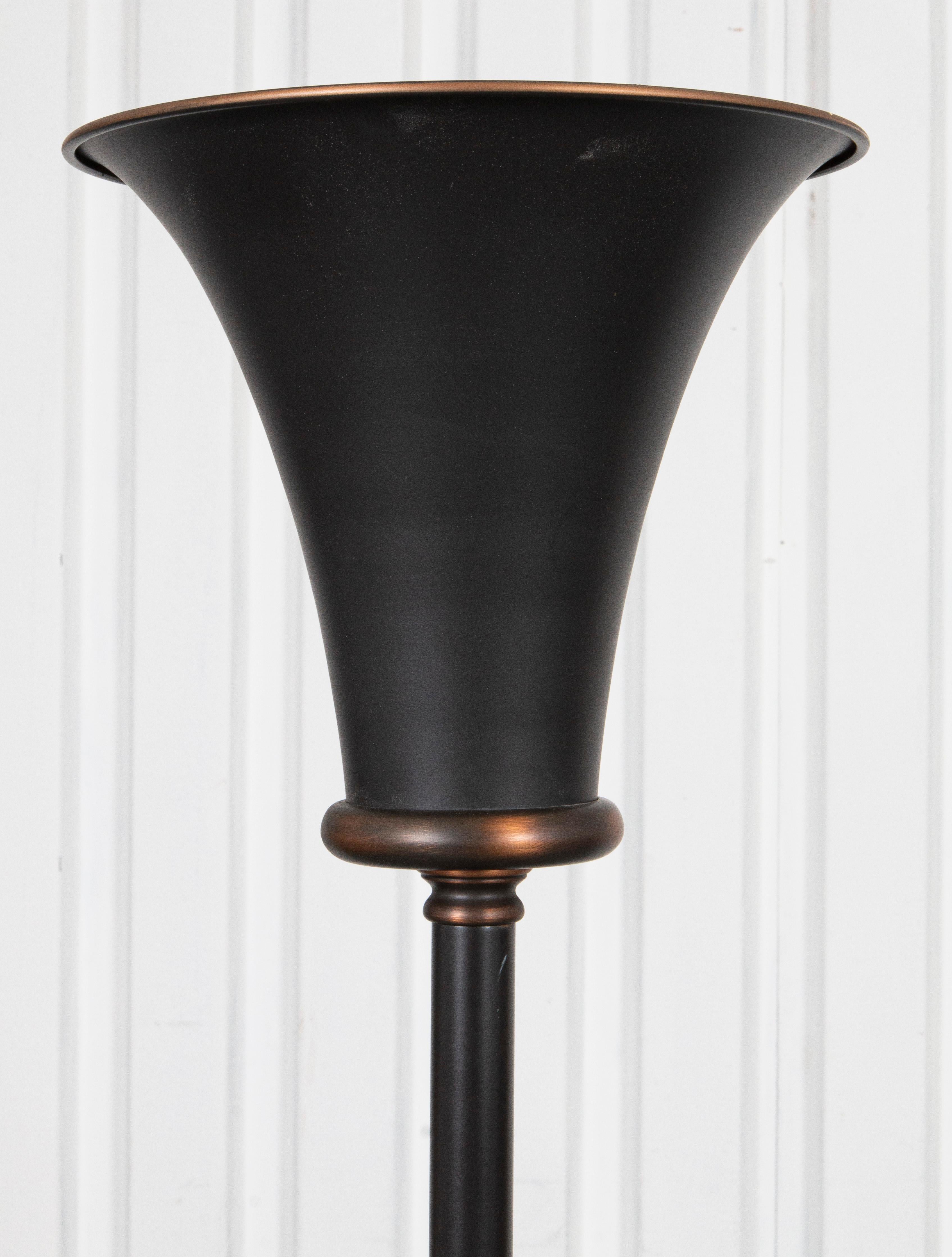 Modern bronze-tone metal torchiere floor lamp.