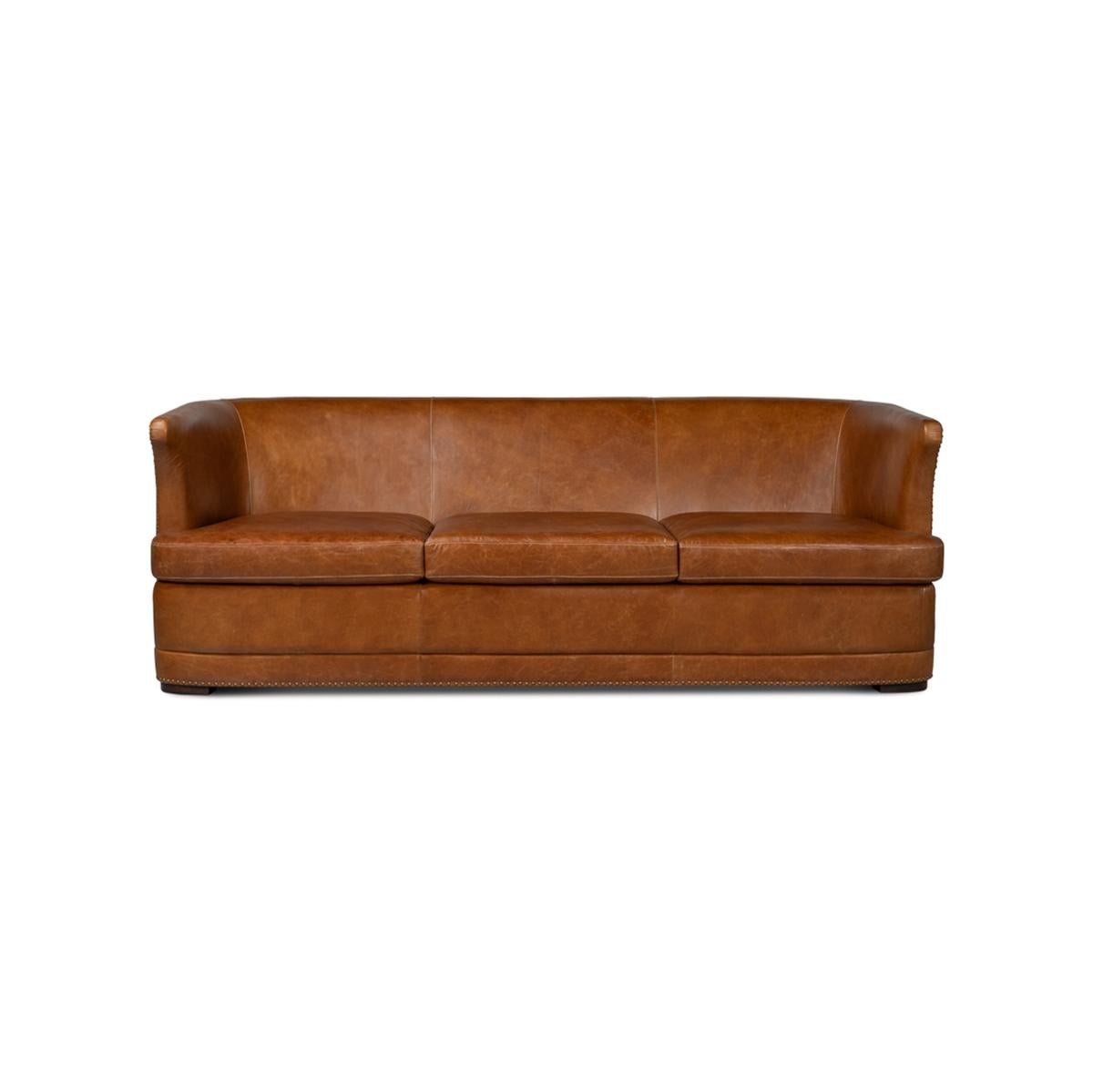 Stunning curvature and inviting supple leather. It is upholstered in Cuba brown leather, with generous depth and a perfect back height. 

With curved back ends and high arms, large antiqued nail heads offer a unique Western rustic appeal to the