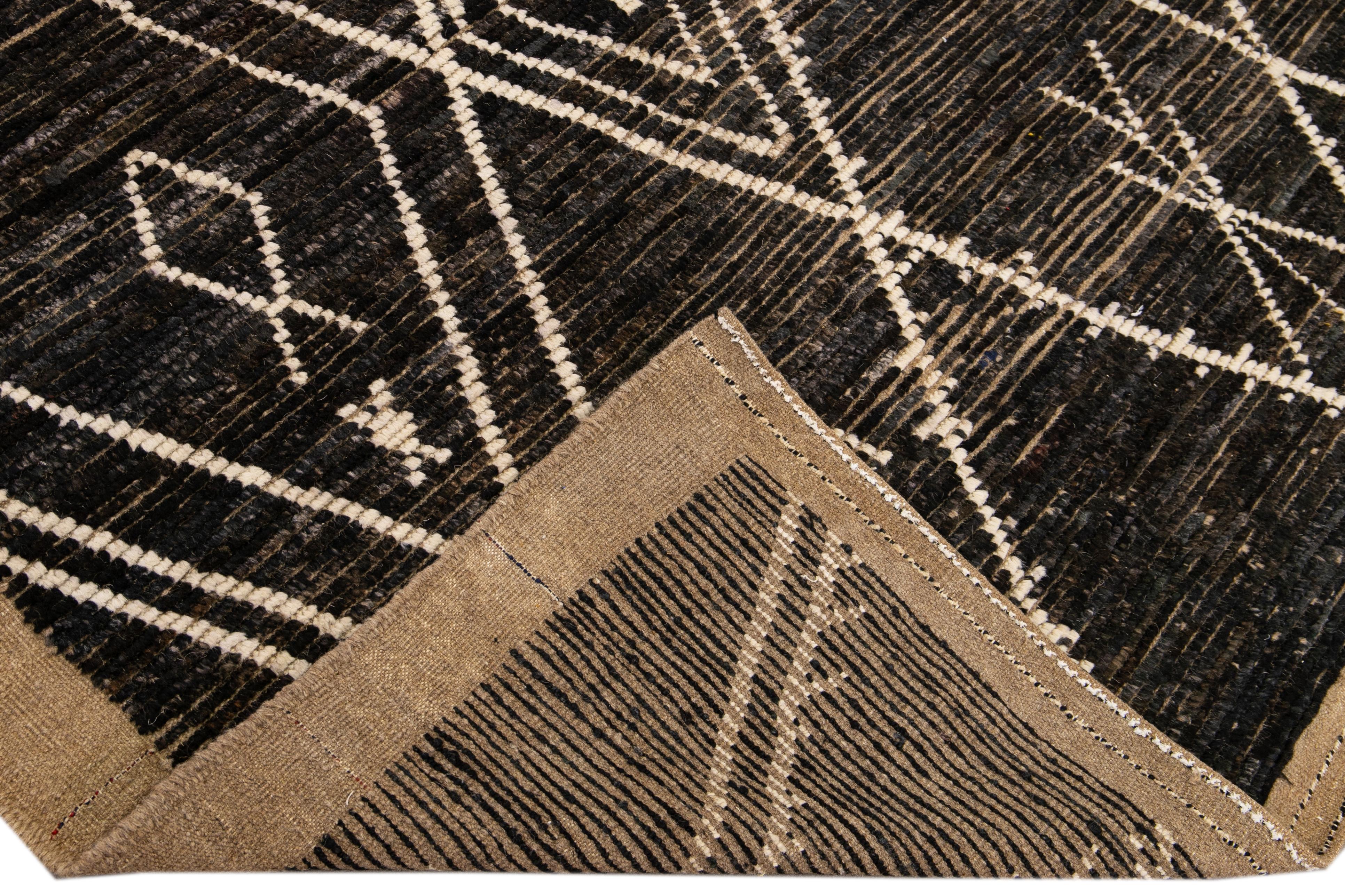 Beautiful Moroccan style handmade wool rug with a brown field. This Modern rug has tan accents featuring a gorgeous all-over geometric boho design.

This rug measures: 5' x 7'.

Our rugs are professional cleaning before shipping.