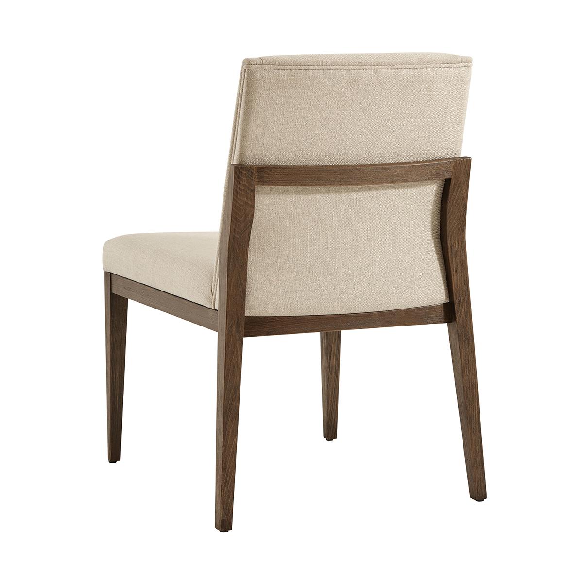 Modern upholstered dining side chair, the brushed beech wood finished in our charteris finish, with an upholstered backrest and bowed seat. Raised on square tapered and out flaring legs. Upholstery is a stain-resistant performance fabric.

Draper