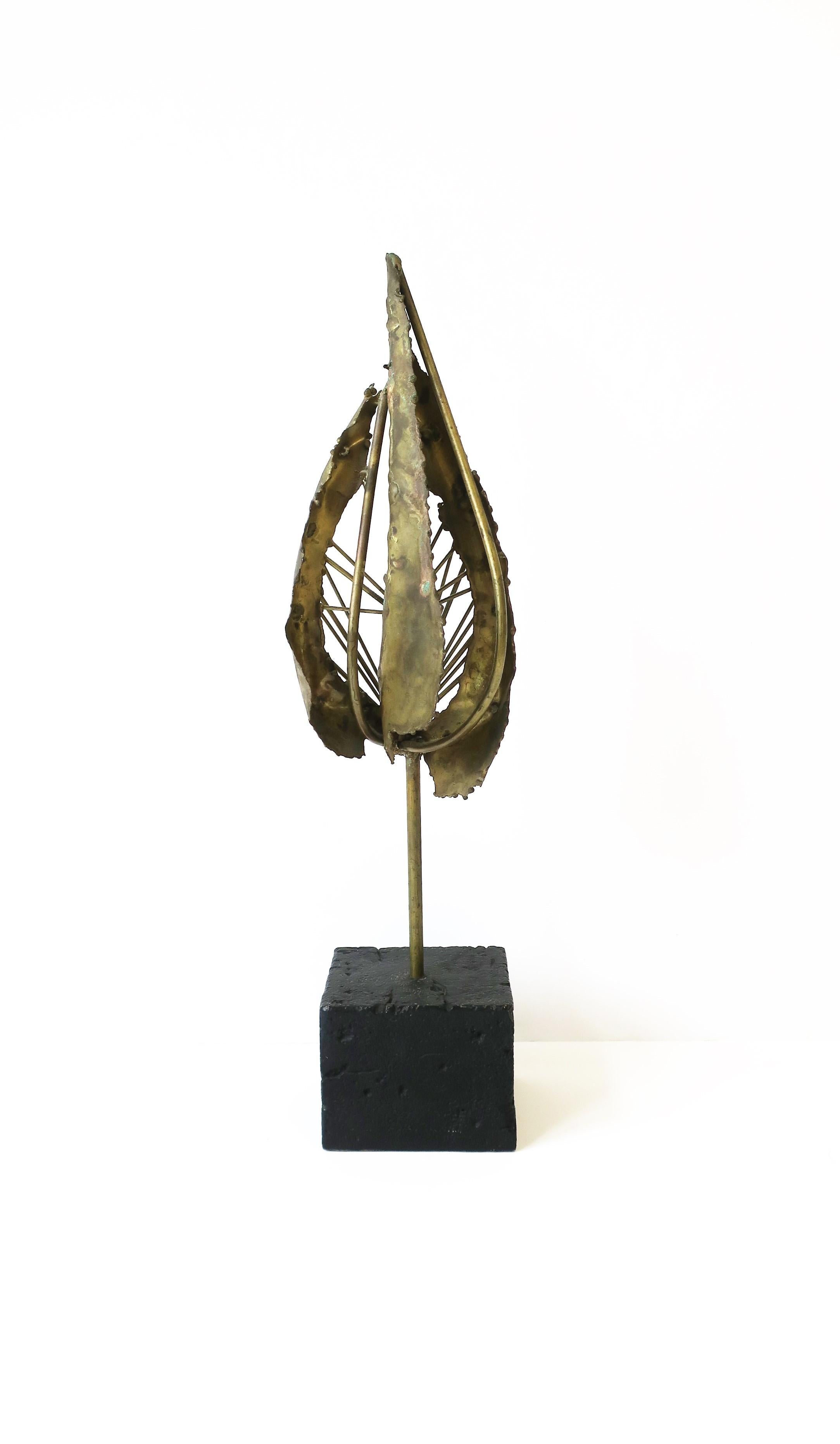 A beautiful hand-made brass sculpture, Midcentury Modern/Brutalist period, circa mid-20th century, 1960s. Piece is unsigned; In the style of designers Paul Evans, Curtis Jere. Piece is all brass with a square black composite base. Very good