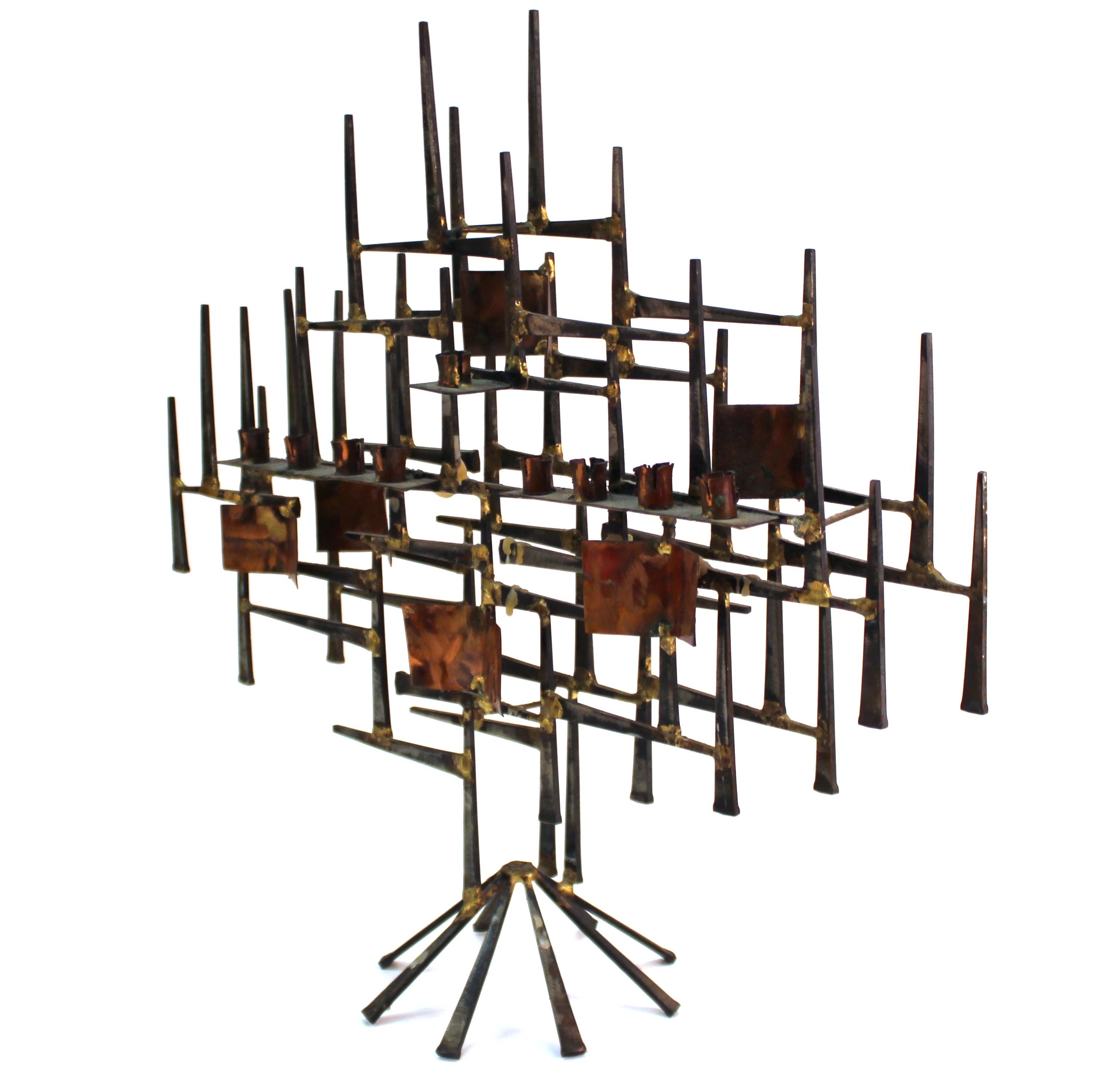 Modern Brutalist period Judaica menorah made in welded metal nails. The piece was likely made during the 1970s-1980s and is in great vintage condition with age-appropriate wear and use.