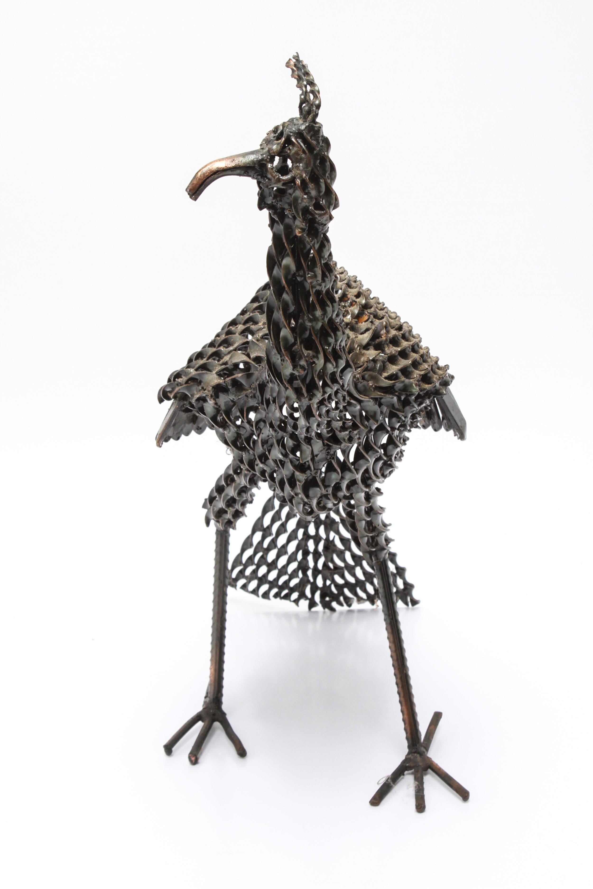 Modern Brutalist twisted metal sculpture of a stylized peacock or peahen bird. The piece is made with elements of twisted metal. In great vintage condition with age-appropriate wear and use.