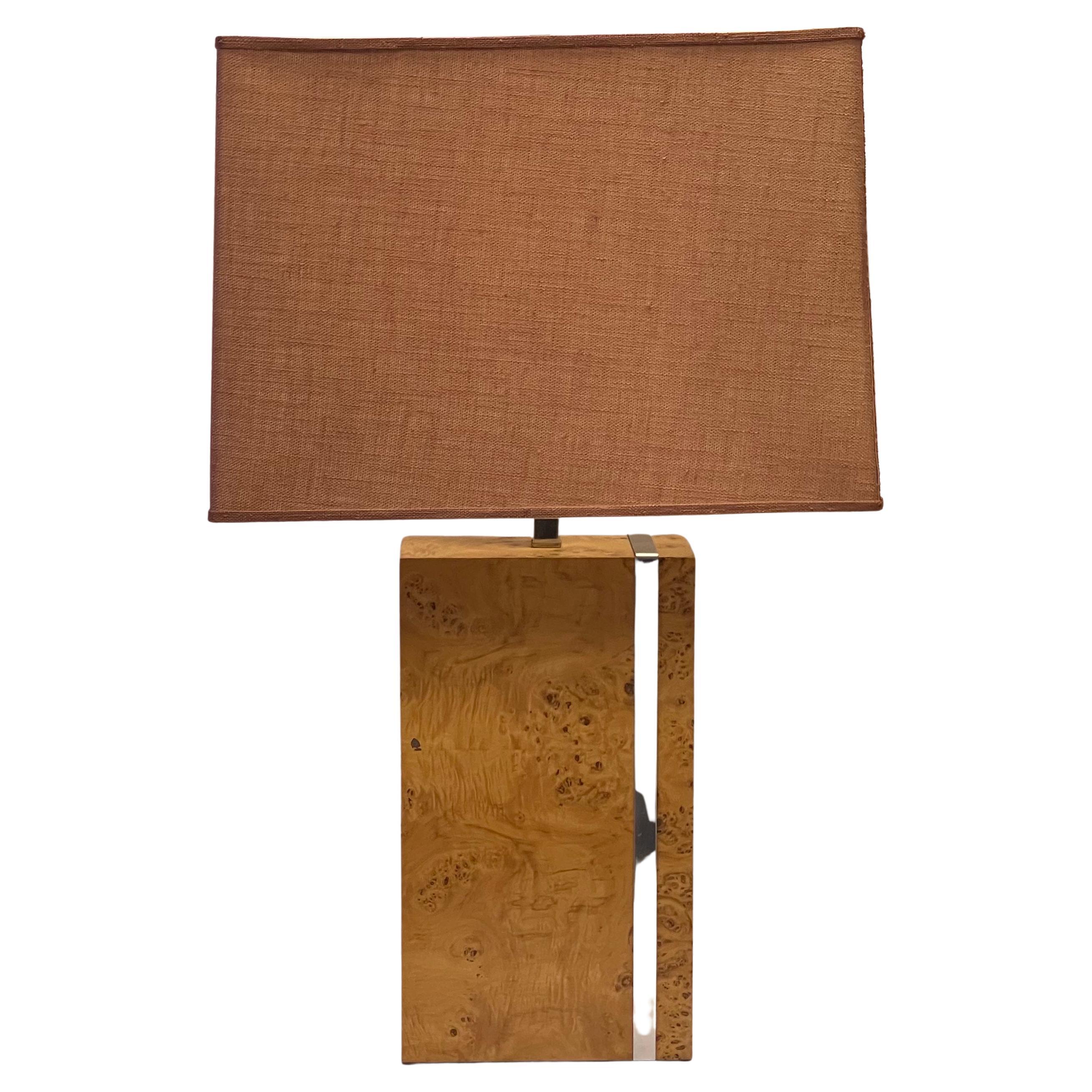 This is a good looking lamp! It is a modern Milo Baughman style burl table lamp. It is unmarked and in very good condition. The shade is as well.