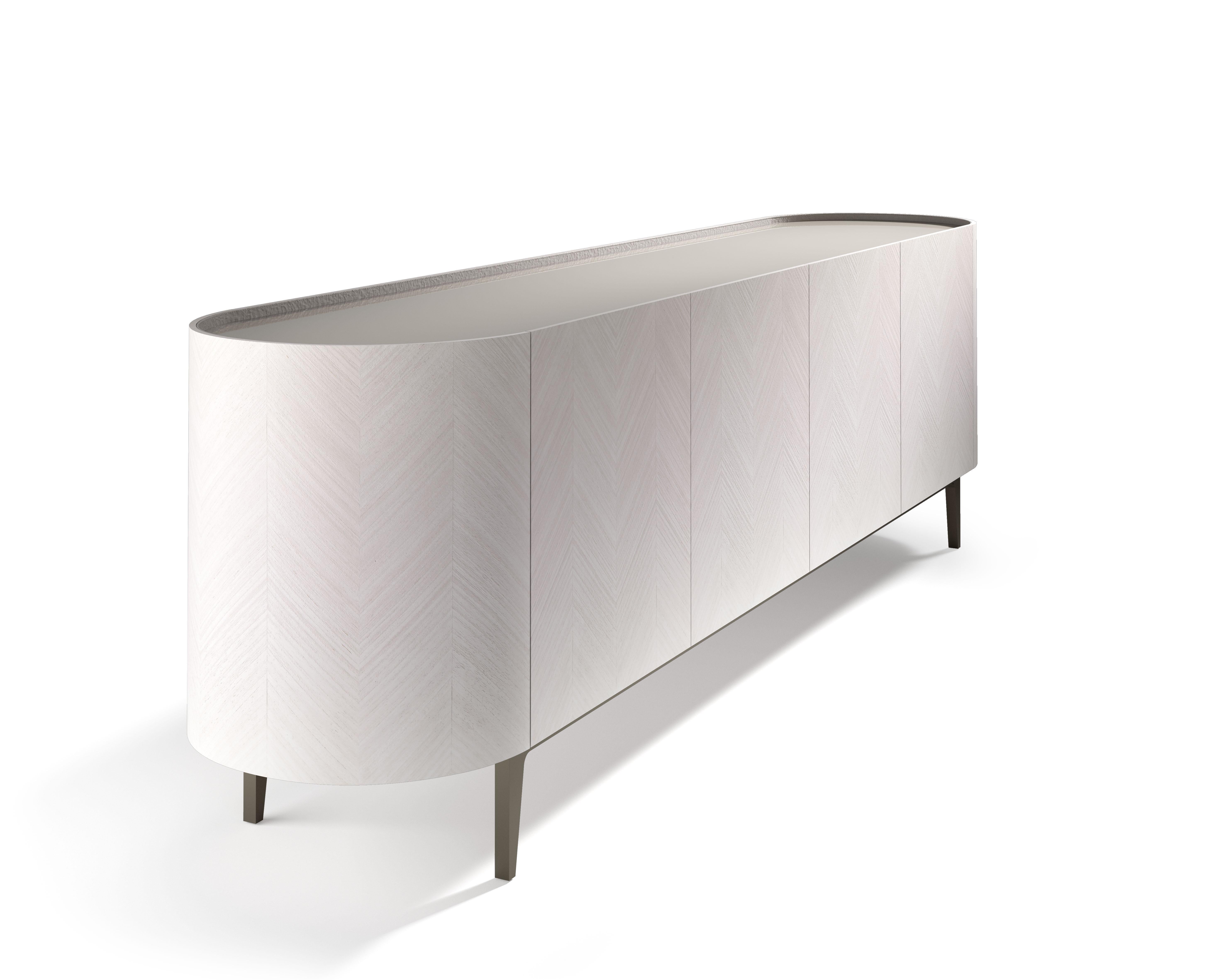 This is a sideboard with a clean line, covering with geometric inlay in precious wood. It is available in light Tay, Dark Tay and Canaletto Walnut. Top with storage unit available in Painted Glass, Marble and Wood. Top profile and chest of drawers