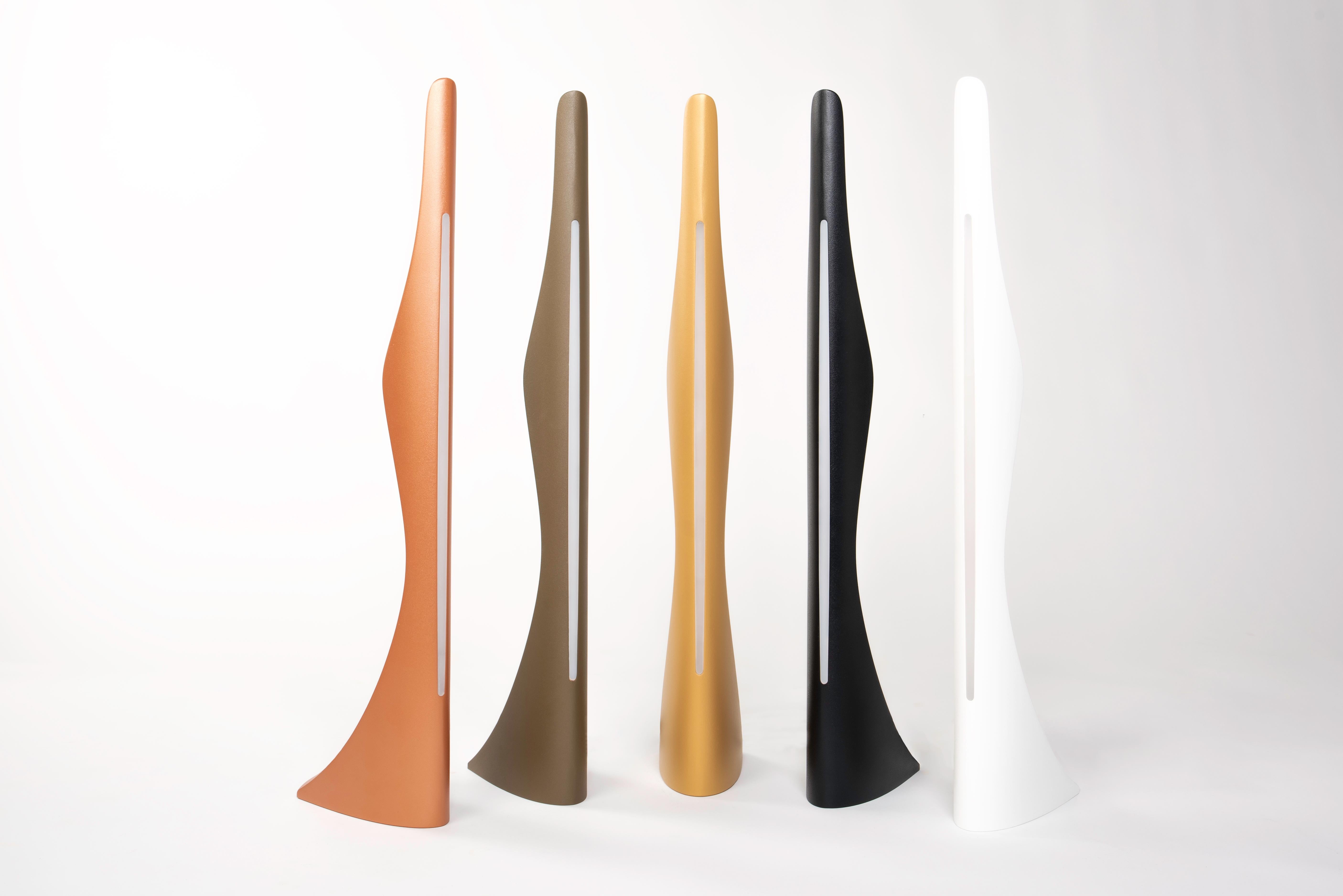 Modern by Cyril Rumpler Handmade Table Light Aluminium Silhouette Copper.
This light is inspired by the silhouette of a woman wearing a haute couture dress with its train and sheath. The dress is worn very close to the body and fits the shapes of