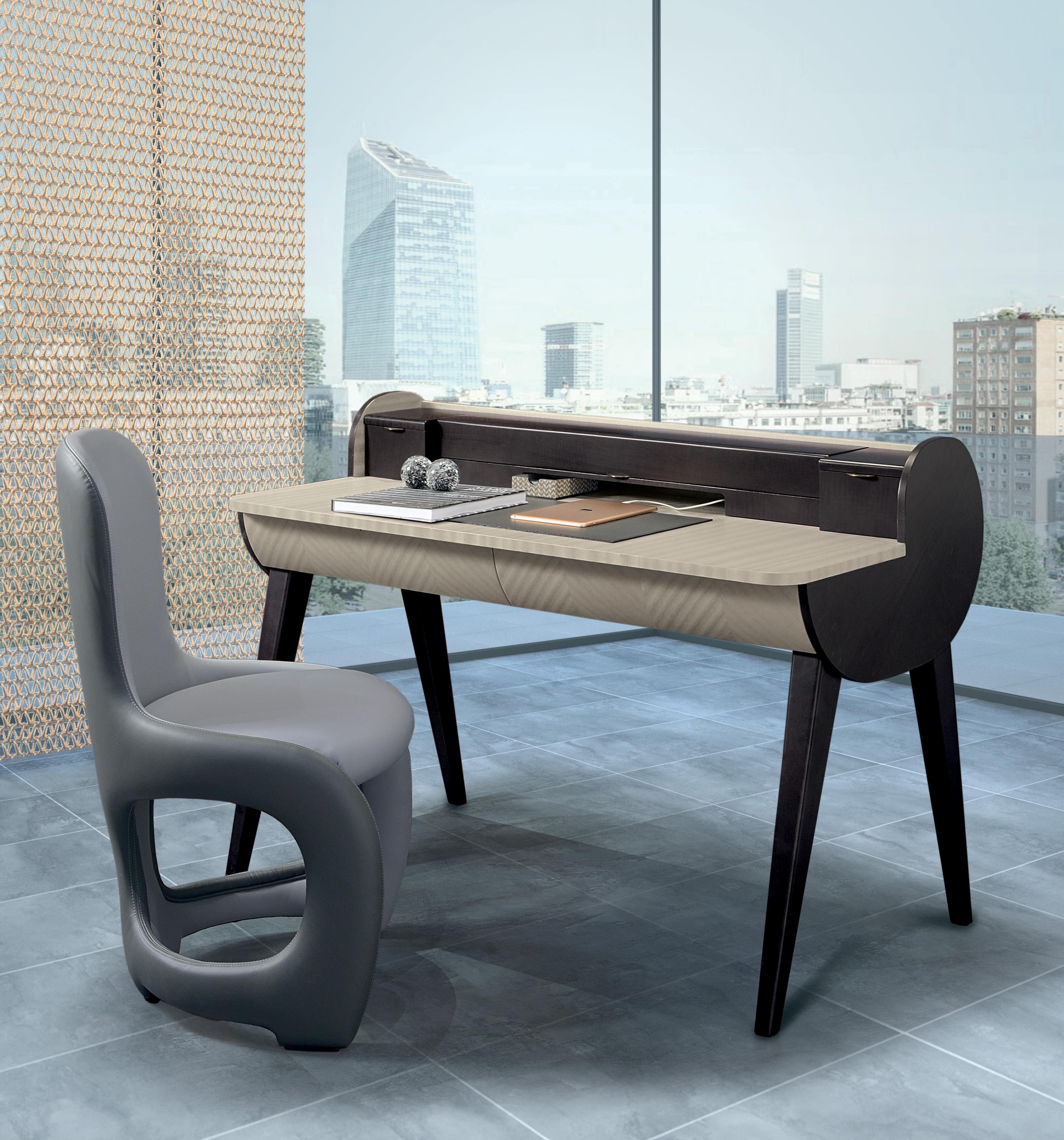 Desk characterized by the cylinder shape. The two sides are in Sycomoro dark frisè wood, internal structure in Pama wood. Horizontal flap door and soft closing. Optional accessories available on request: leather desk pad, business cards holder,