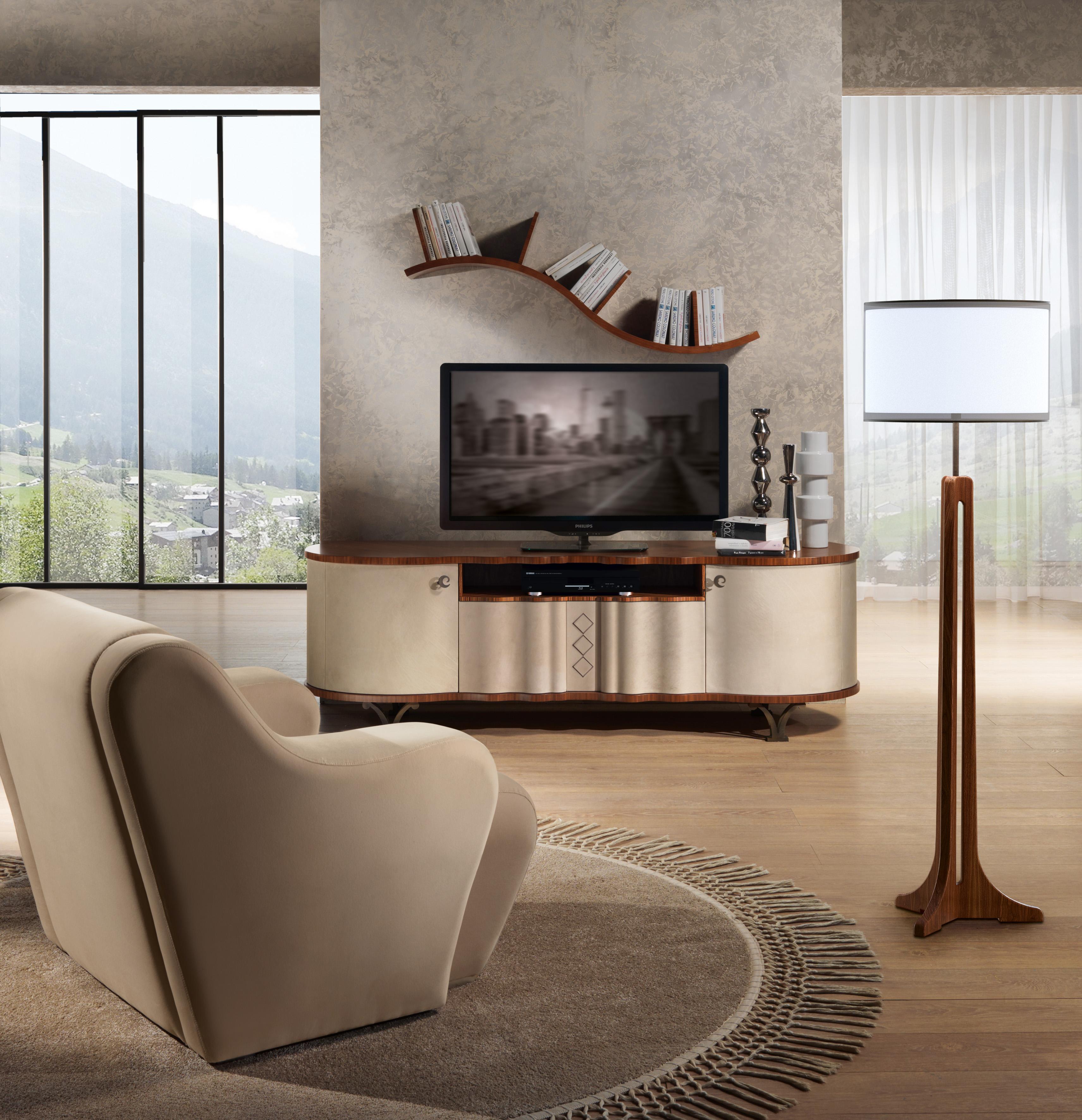 TV stand in wood coated leather. Top in natural walnut. Feet in steel, brushed bronze finishing. Handles in steel, brushed bronze finishing. Upholstery in nabuk leather, decoration: embroidery in narrow windings wire.