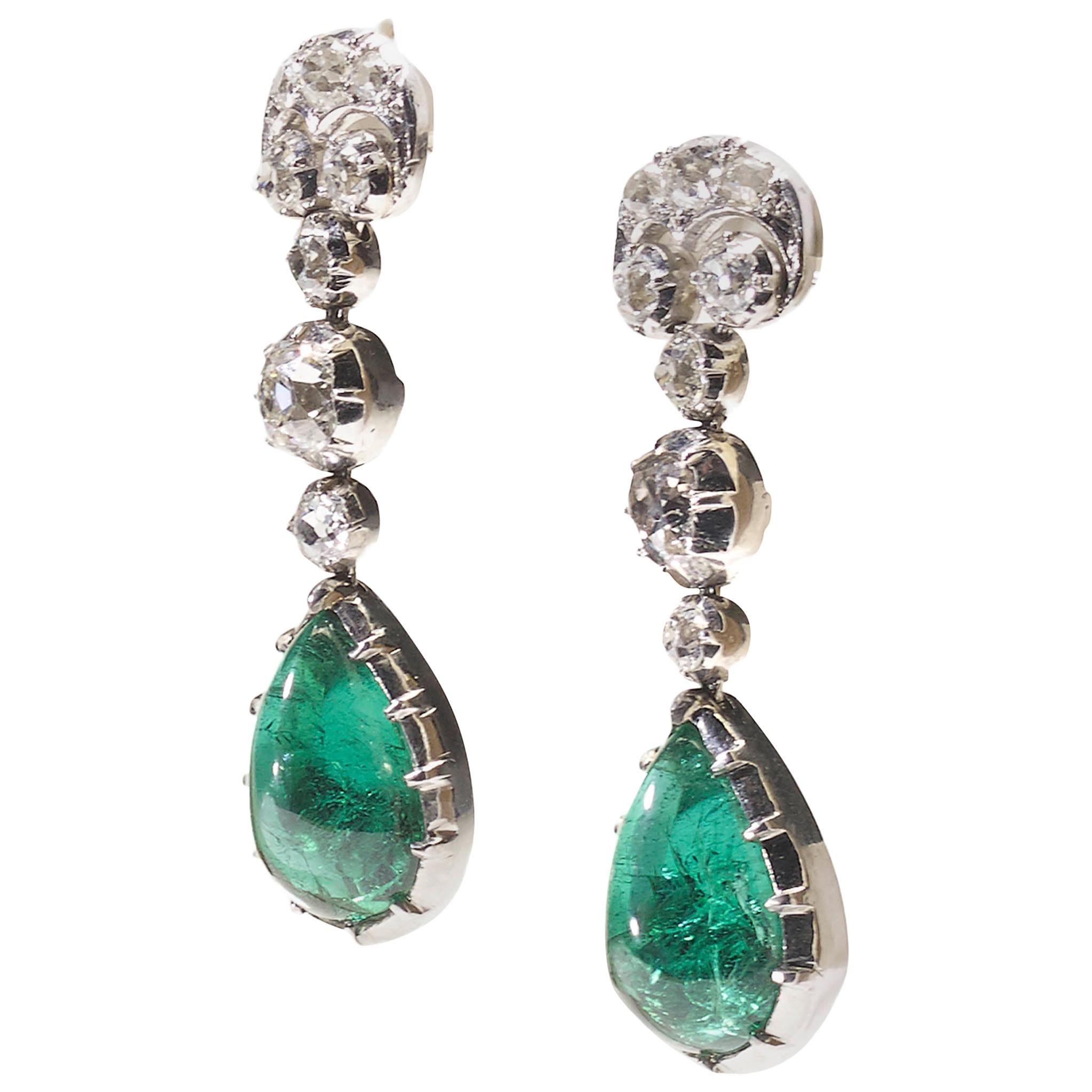 A pair of modern, cabochon emerald and diamond earrings, with old-cut diamonds set in the scroll tops and three diamonds in cut down settings, with an approximate total diamond weight of 2.50ct, with cabochon-cut emerald drops, with a total weight