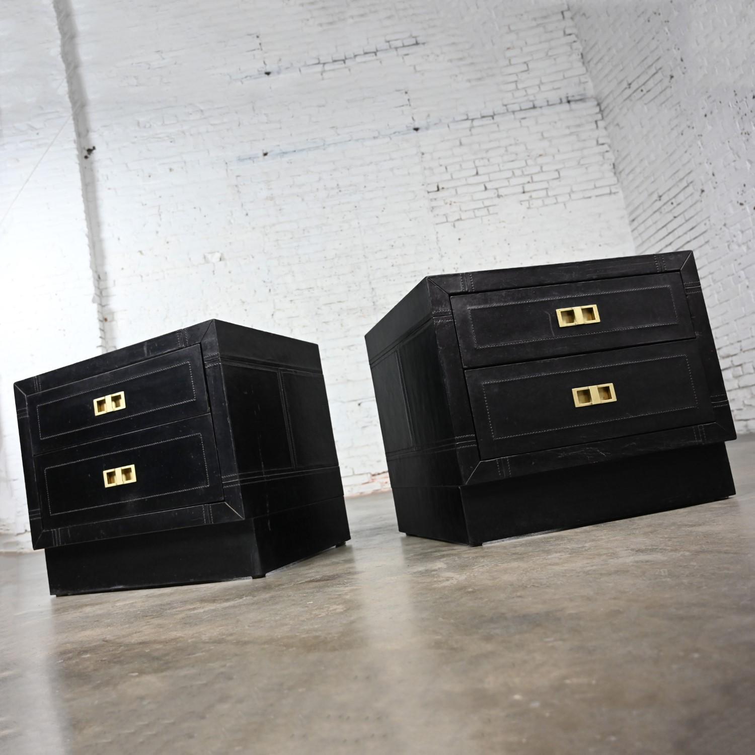 Stunning vintage Modern or Modern Campaign style black espresso dyed leather covered end tables, nightstands, or cabinets with solid brass hardware, a pair. Beautiful condition, keeping in mind that these are vintage and not new so will have signs