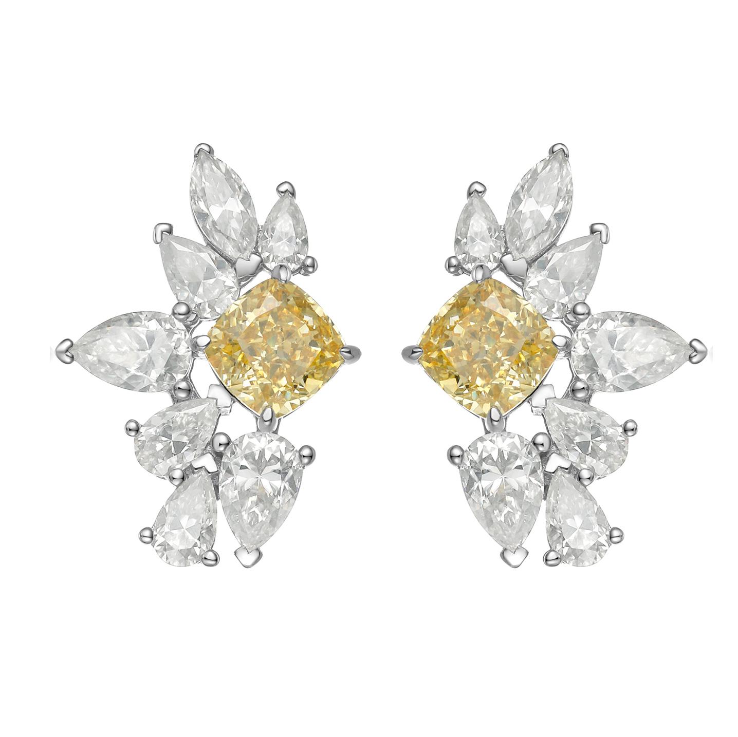 These mesmerizing fancy yellow canary earrings are custom made to perfection! The gorgeous matching radiant cut diamonds have a beautiful medium canary yellow color. These earrings are set in 14k white gold and are surrounded by numerous stunning