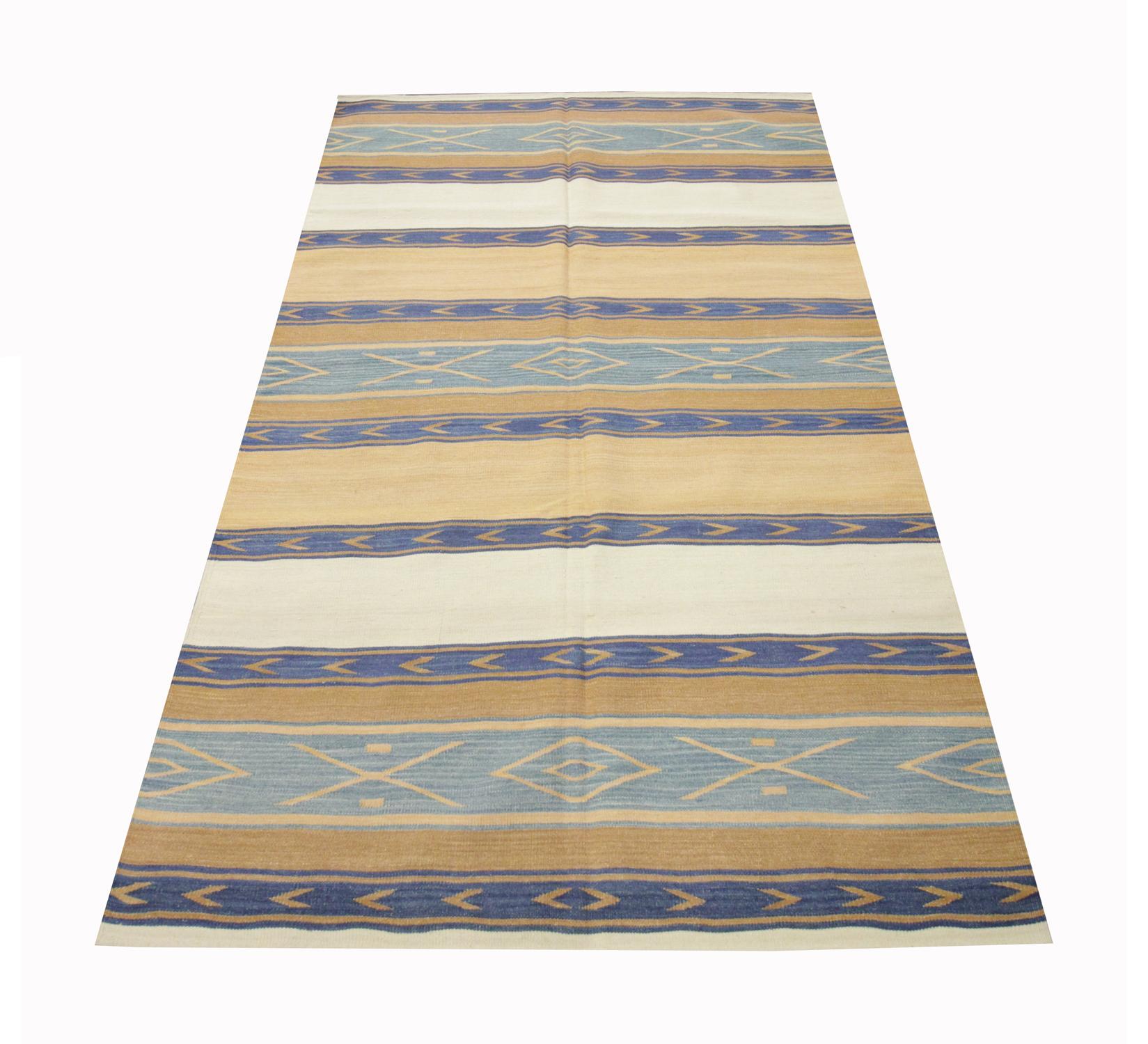 This simple stripe wool rug is a modern kilim woven with a simple colour palette including beige, cream and blue with Geometric patterns woven throughout the blue stripes. The colours and design in this wool kilim make it the perfect accent rug for