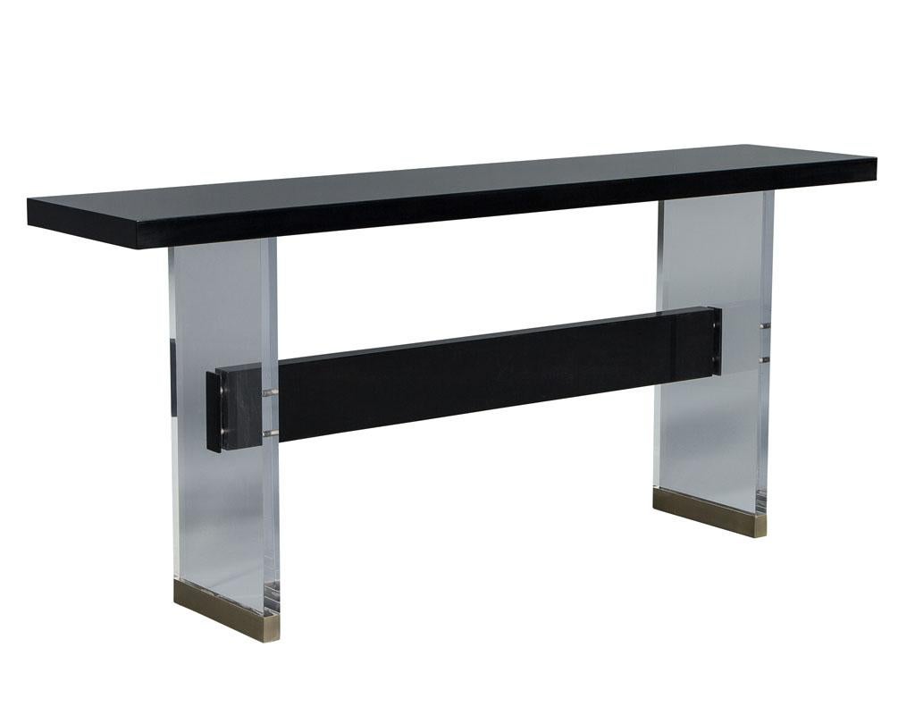 Modern Carrocel custom acrylic, black lacquer and walnut console. Custom built here at Carrocel in Toronto, Canada using the finest materials available. Featuring beautiful acrylic legs finished with brass trim feet. Truly a showstopper for