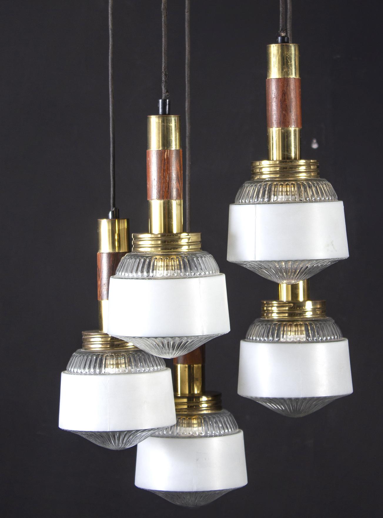 Modern wood and brass cascade chandelier with five glass cup.
 Five E 14 light bulbs.