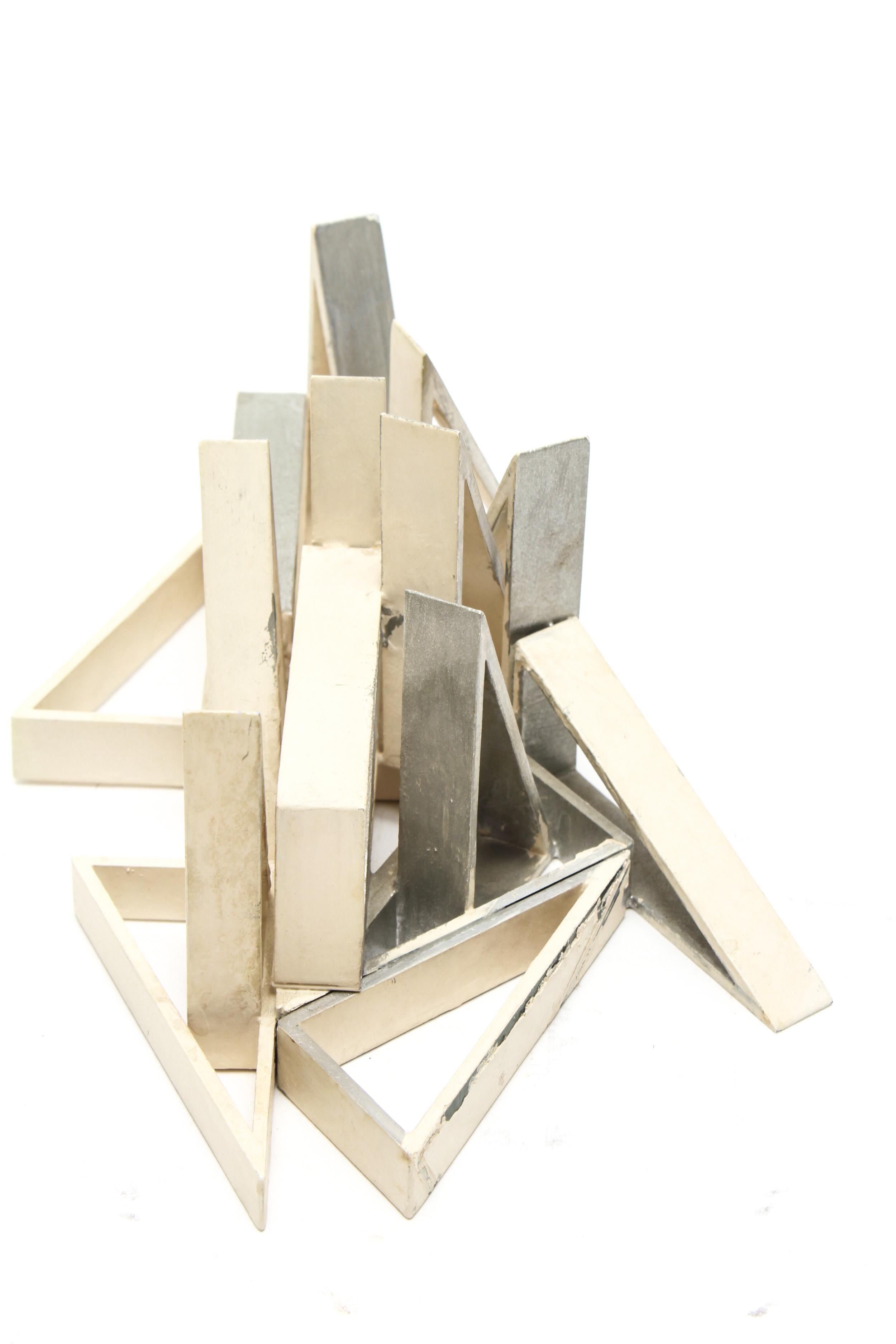 Modern geometric triangles tabletop sculpture in cast aluminum. It was likely made during the mid-to late 20th century. The piece is in great vintage condition with age -appropriate wear.