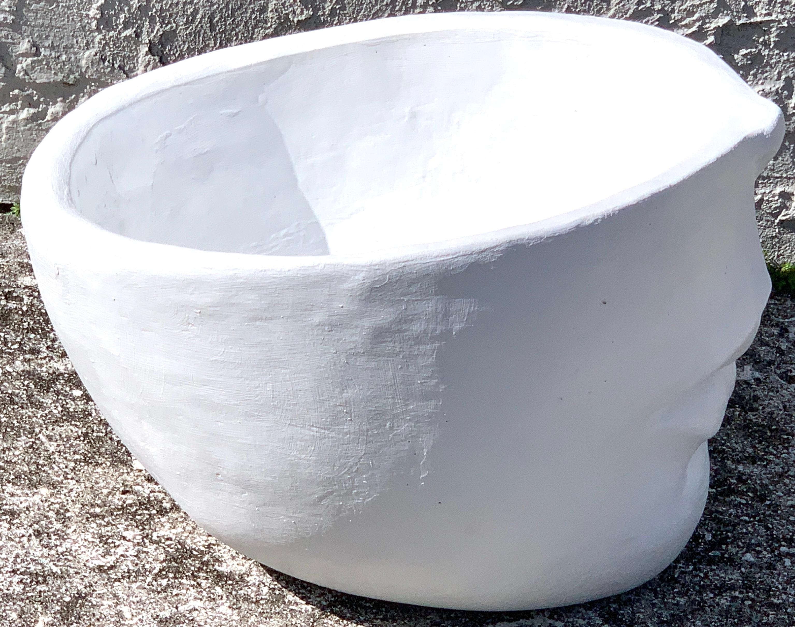 Modern cast stone half face planter, sculptural and sturdy. Ready to place.