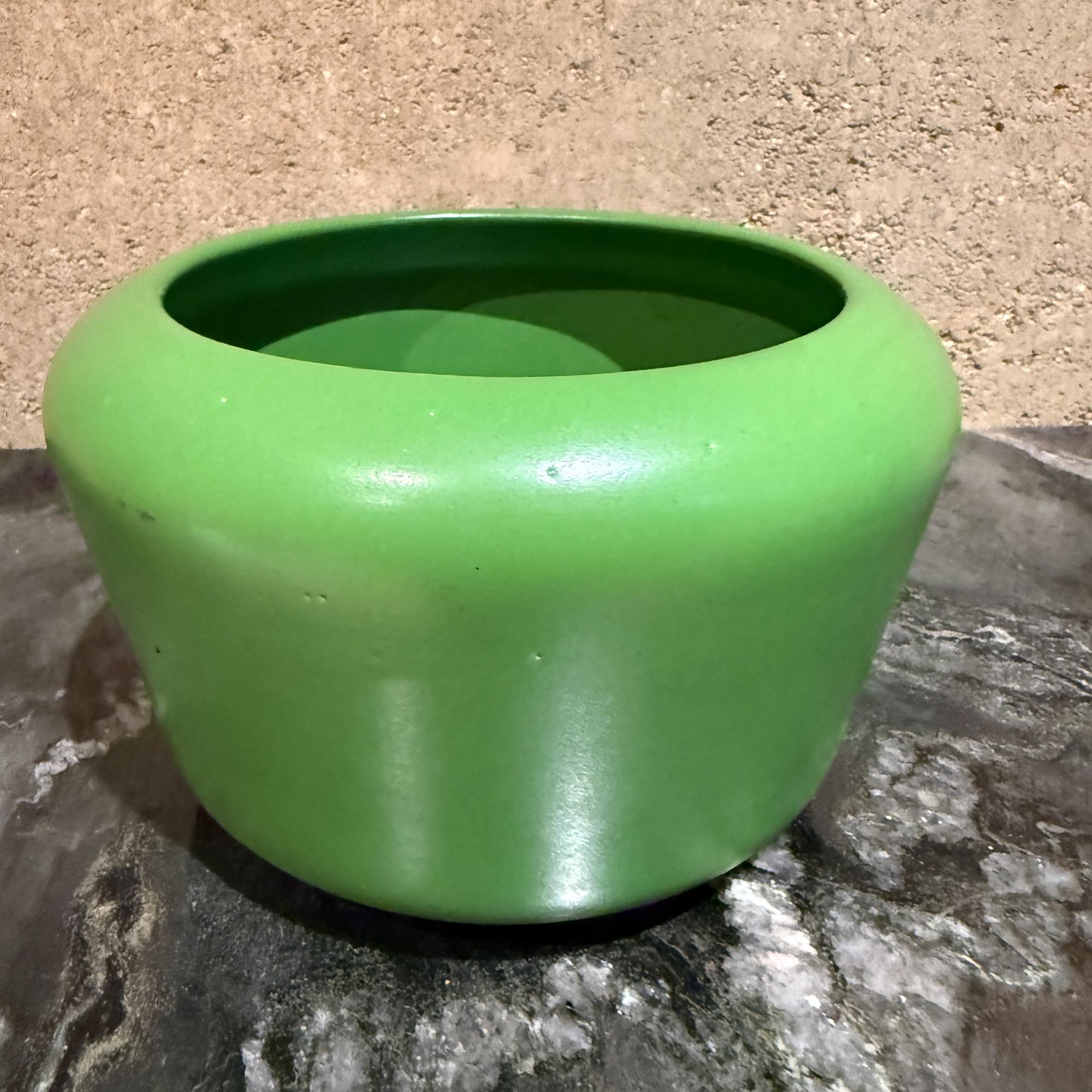 For your consideration,  a vintage or modern ceramic planter or pot in a vibrant green color. 
The object features a wide, rounded shape with a slightly flared rim.
It is made of a glossy, glazed ceramic material.
The bright, solid green hue