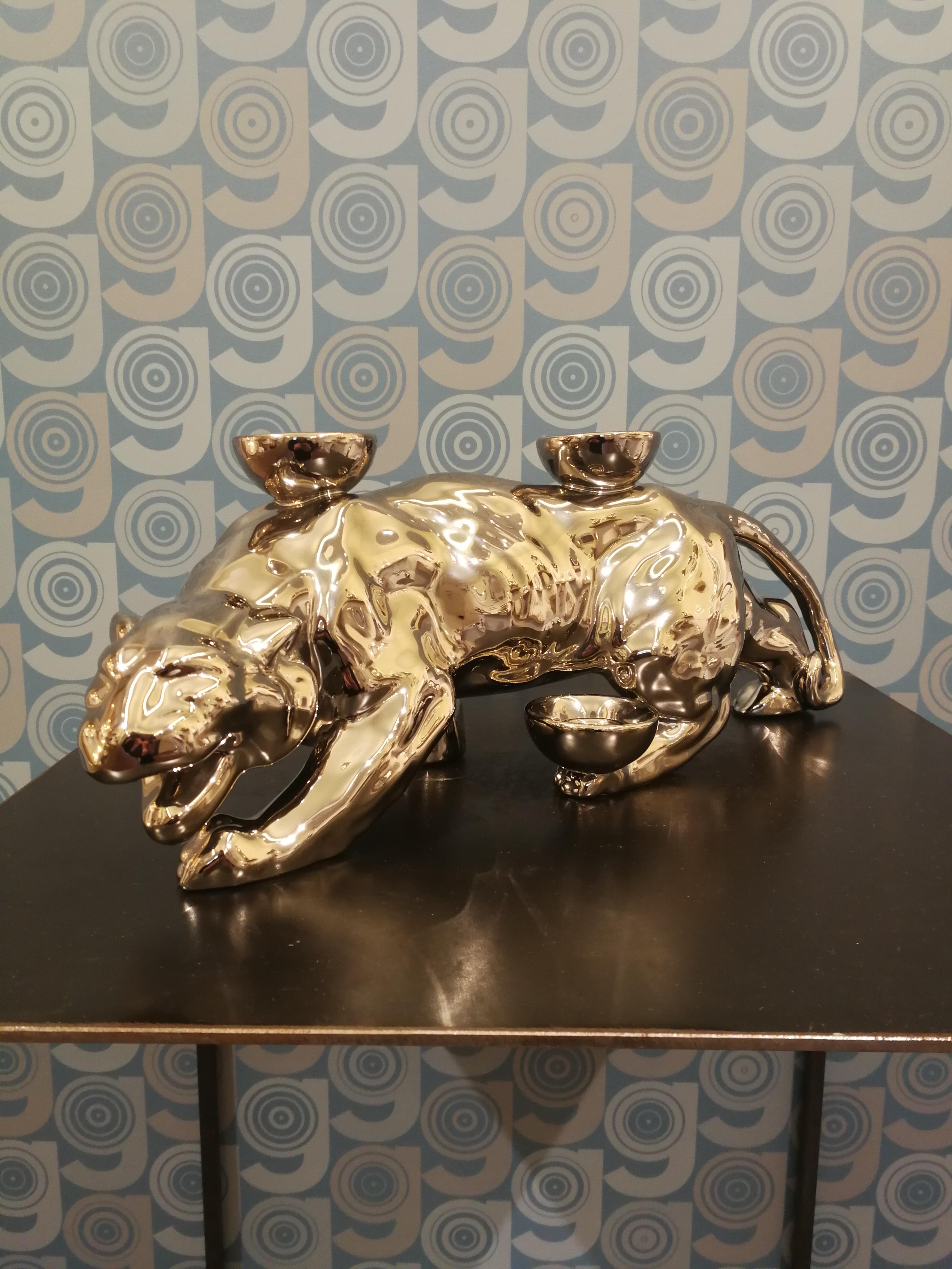 This panther is part of an original collection of candle holder animals. The realization of the shape takes place through a mold with liquid clay; tiled and hand painted in a vast range of colours, from the most delicate pastels to the more