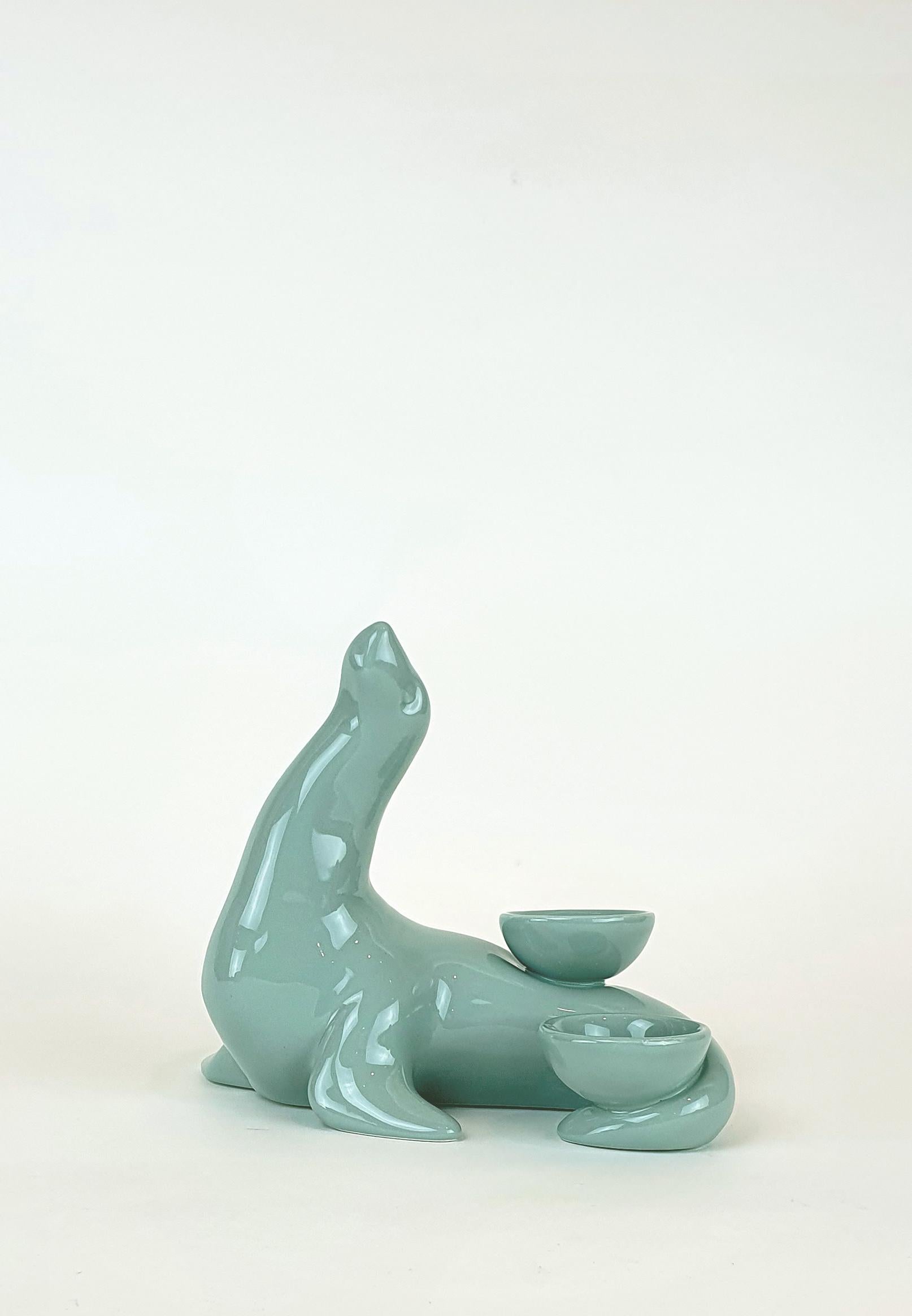 This seal is part of an original collection of candle holder animals. The realization of the shape takes place through a mold with liquid clay; tiled and hand painted in a vast range of colours, from the most delicate pastels to the more saturated