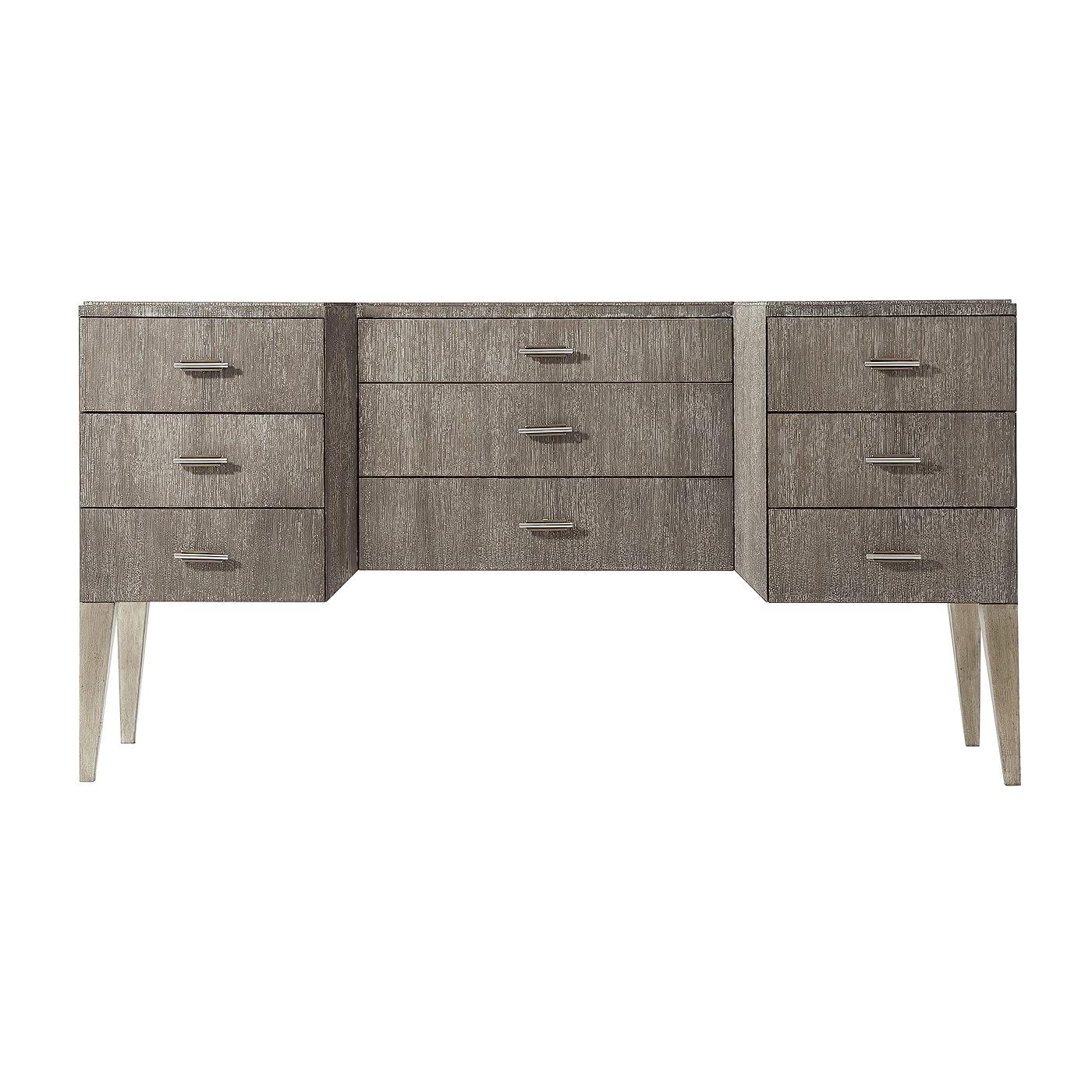 Modern cerused oak breakfront dresser with nine self closing drawers, brass and stainless steel handles and raised on brush pewter legs. With soft slow closing drawer runners.
Dimensions: 62
