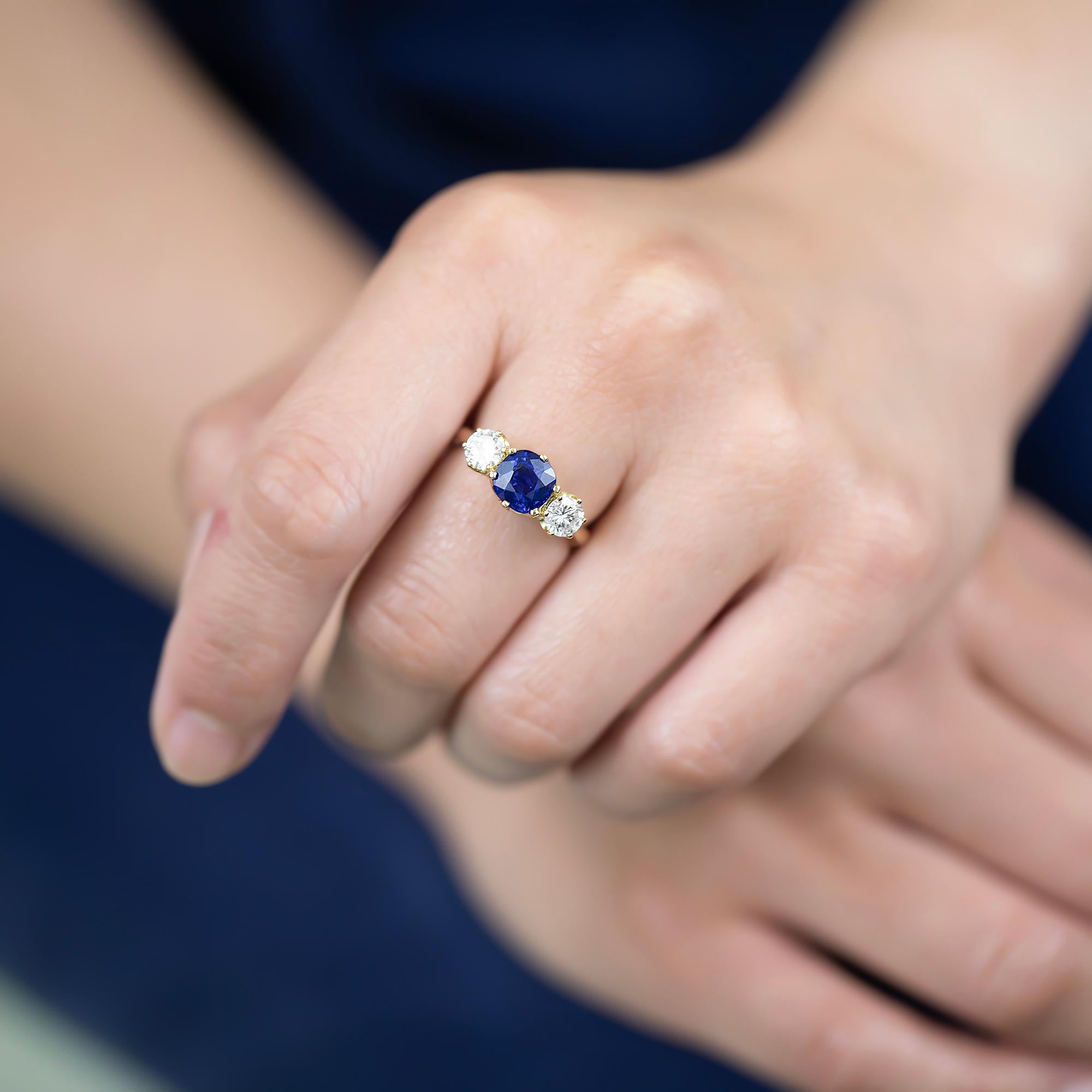 Modern handmade sapphire and diamond ring featuring scalloped setting with reverse taper band. This ring has been made using these gorgeous stones which we recycled from an estate ring. They are gorgeous, bright stones. A fabulous choice for a