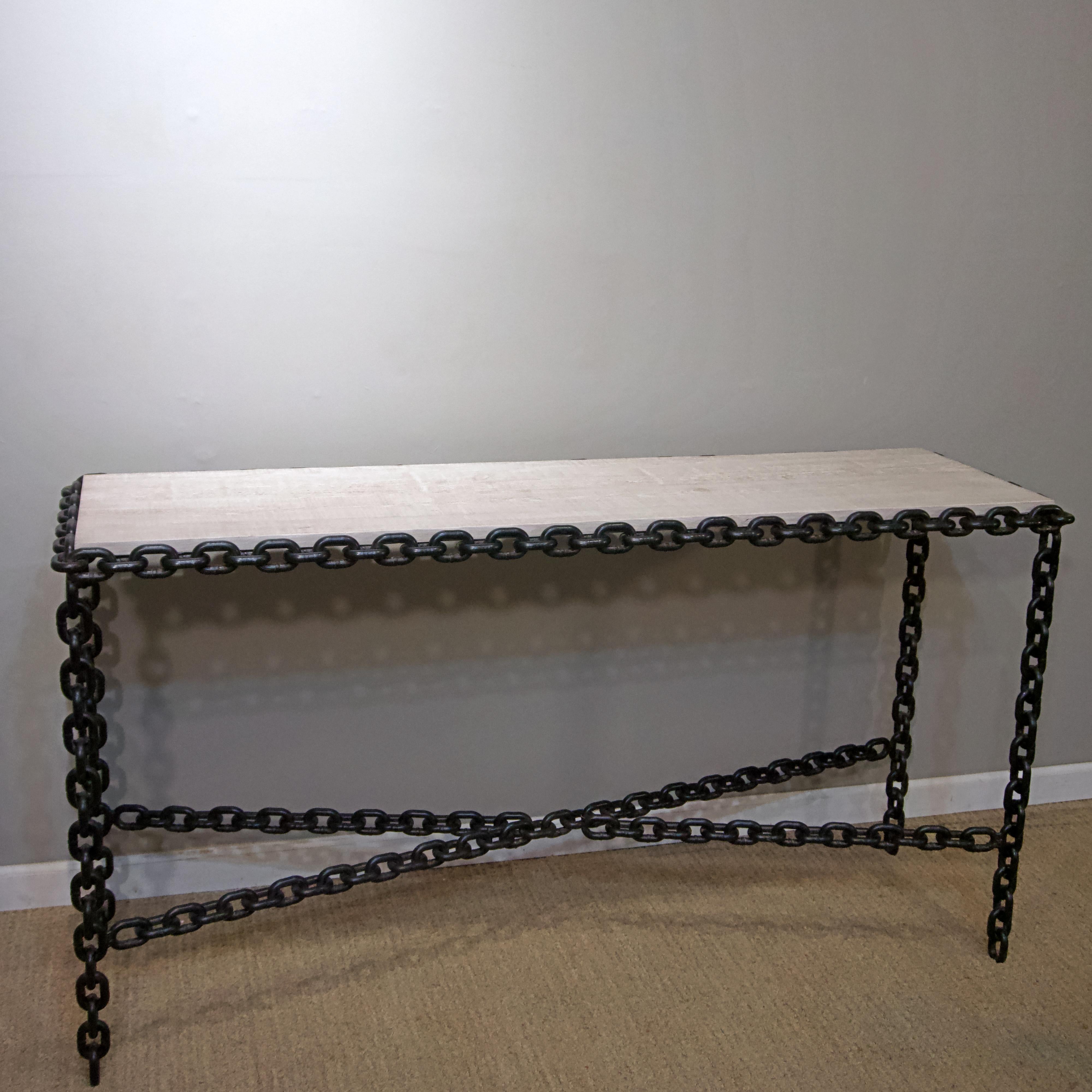 Fabricated from welded chain links with a cerused oak top.
   